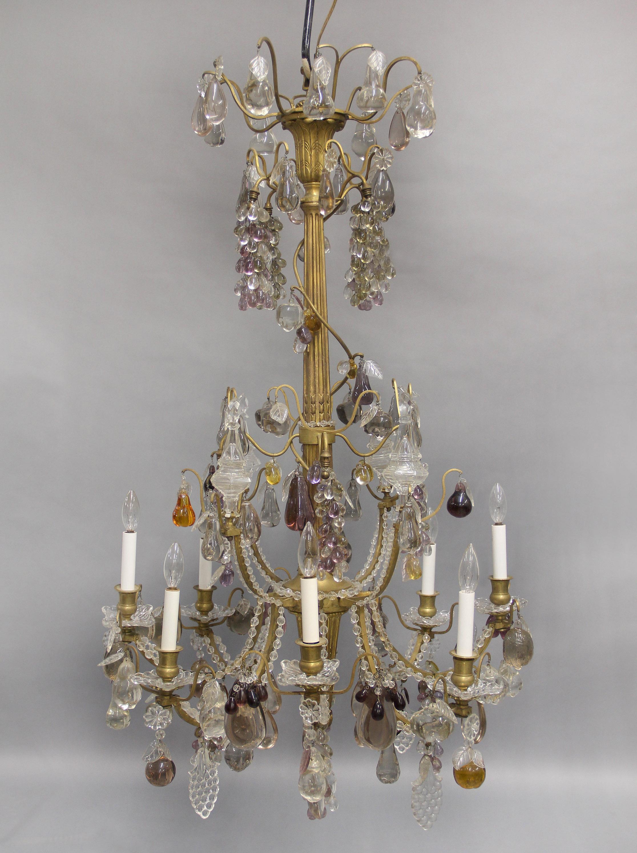A Very Interesting Late 19th Century Giltwood, Gilt Bronze and Fruit Crystal Eight Light Chandelier

The bronze and wood frame highly decorated with many different hanging clear and colored crystal fruit, including apples, grapes, pears, and plums,