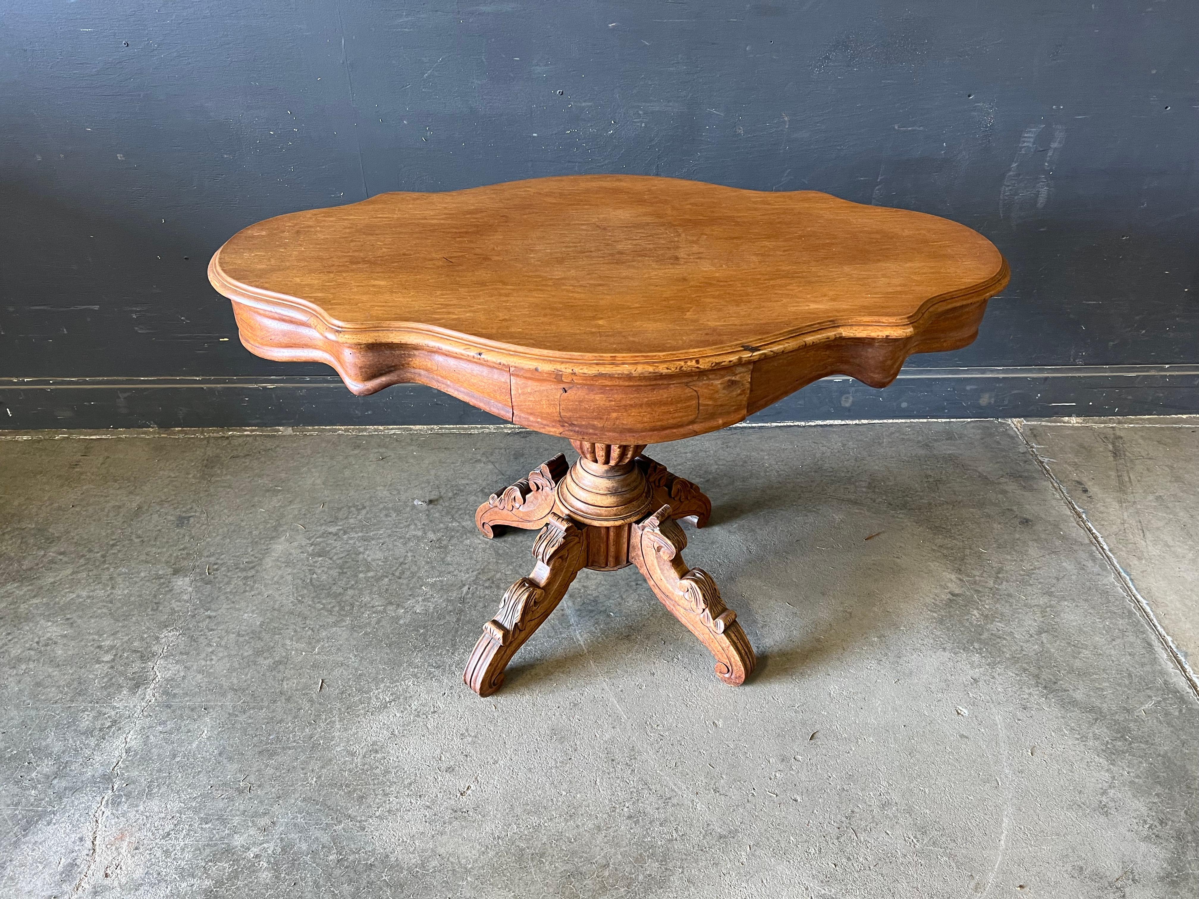 Unusual table, either Swiss or Swedish. Was brought to the USA by cellist Haim Zemach. Has two drawers. With partial label underside of table. Great form and turnings on base and top. Maker is unknown.