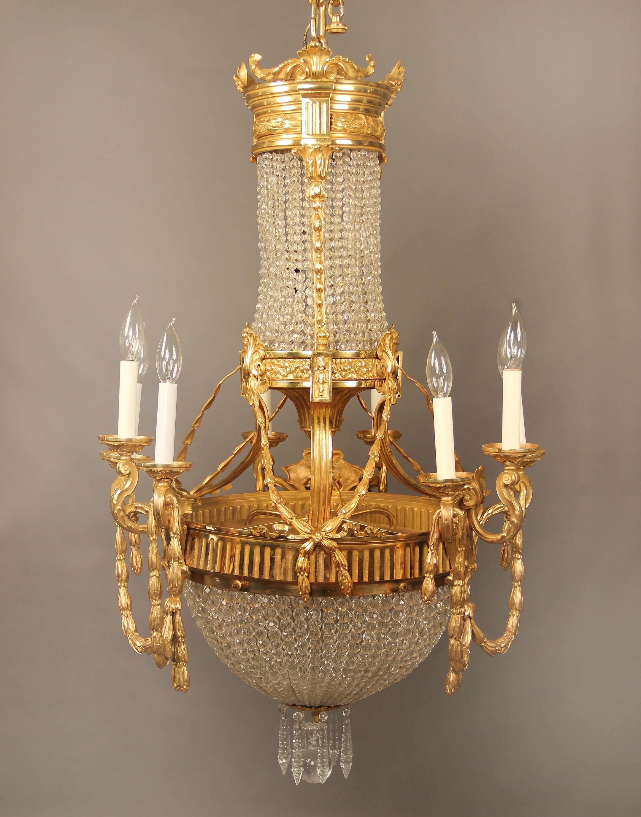 An interesting late 19th century gilt bronze and crystal fifteen-light basket chandelier.

Bronze rope and bow designs along the body and arms, crystal beaded body and basket, nine perimeter and six-tiered interior lights.

If you are looking