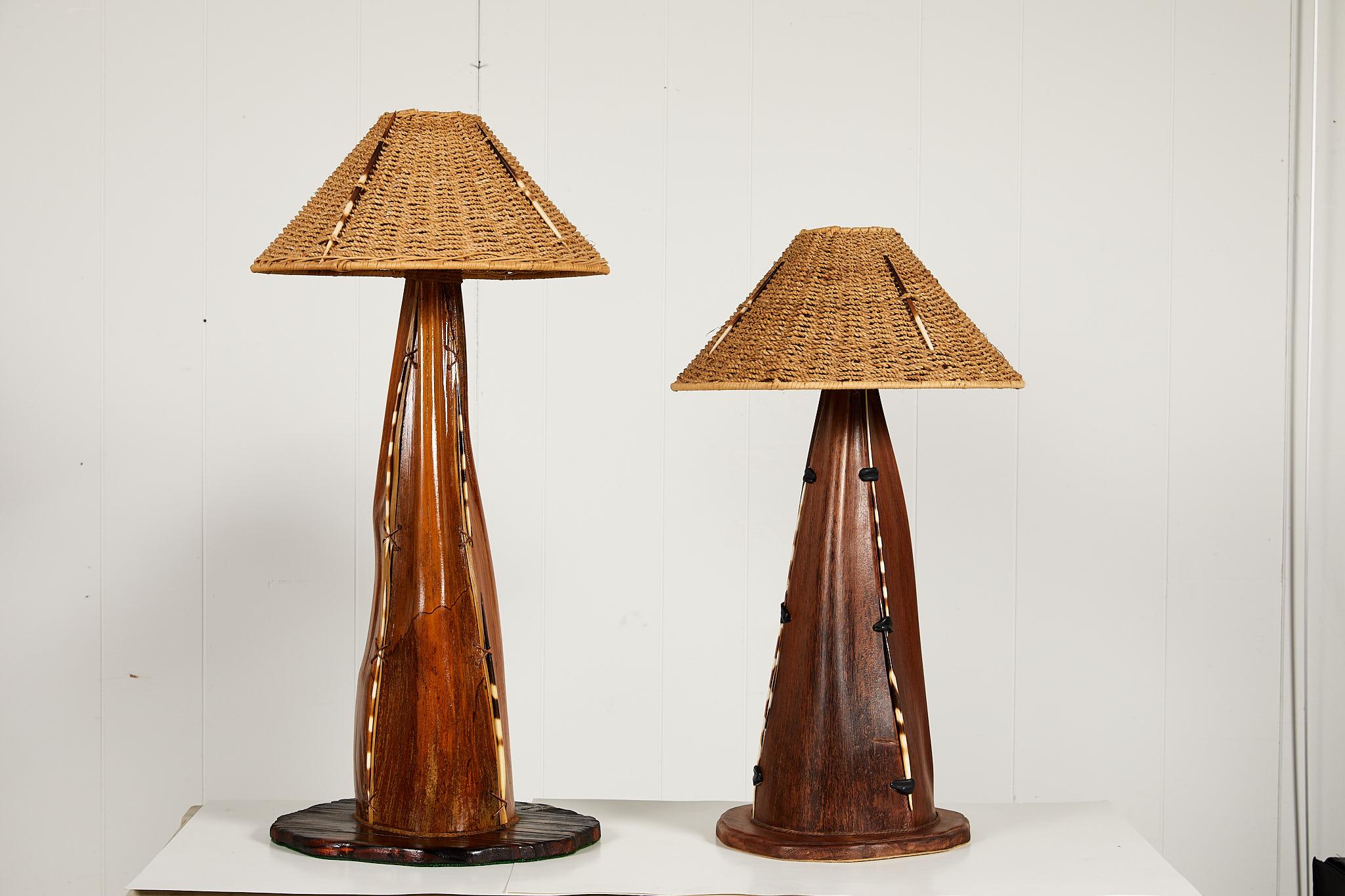 Unusual 20th century friendly pair of Folk Art lamp bases creatively made of palm frond seed pods. The palm fronds were stained and mounted onto hand carved wooden bases. Quills are attached by cord and leather to decorate the seams. Each lamp is
