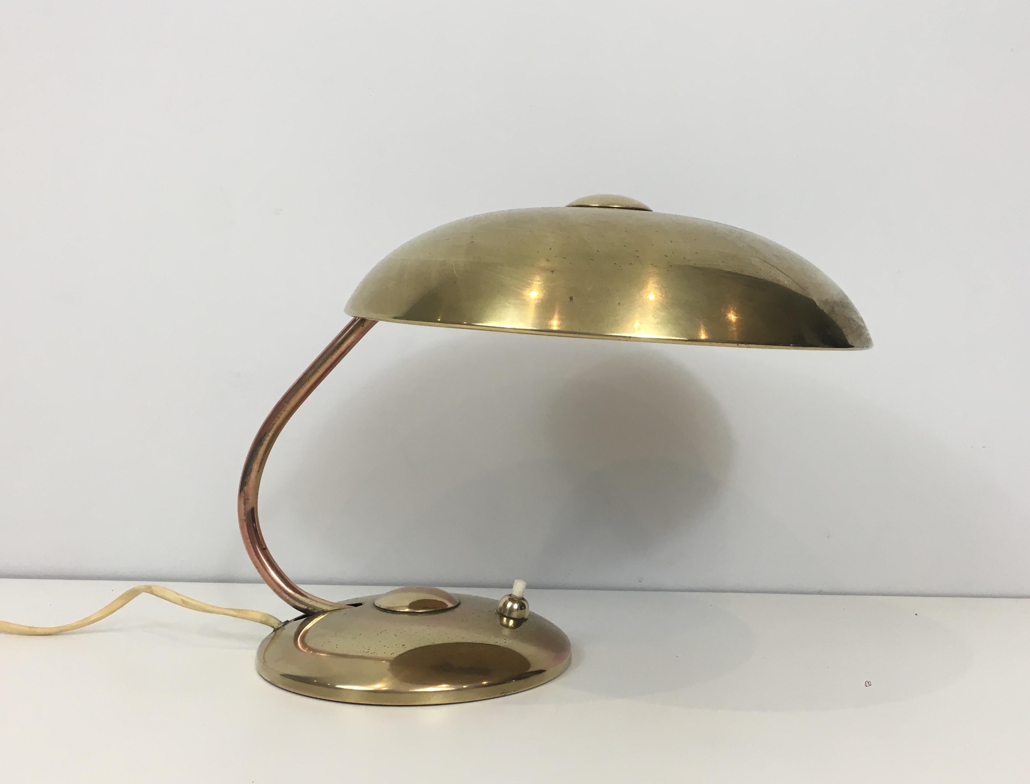 In the style of Maison Perzel. Interesting small brass desk table lamp. The brass shade is removable. French, circa 1930.
