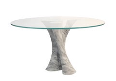 Interface carved solid marble block dining table with glass top.
