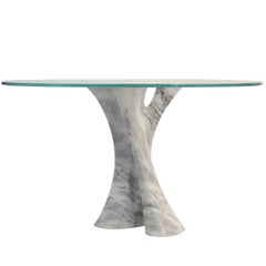Interface carved solid marble block dining table with glass top.