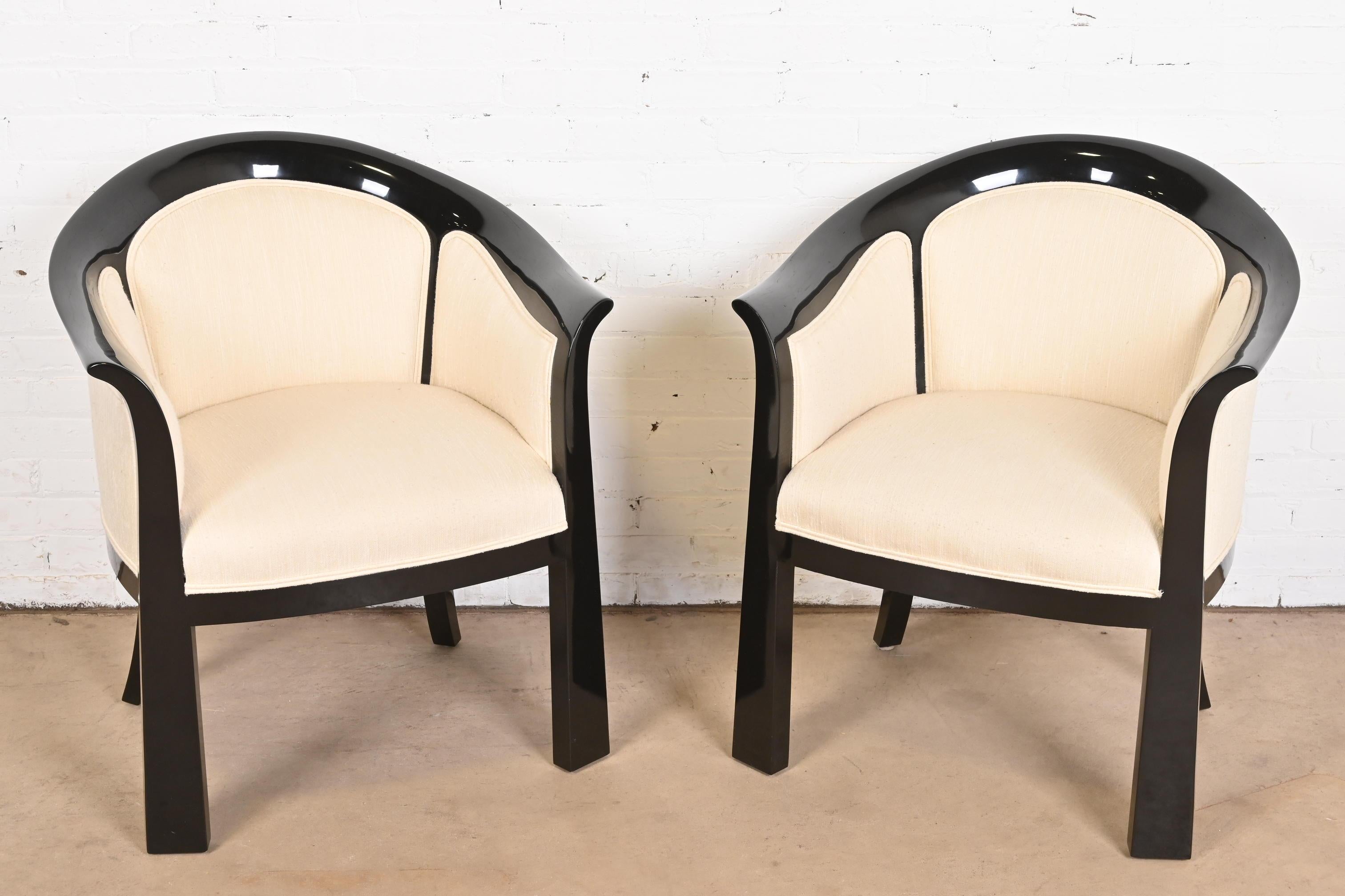 An exceptional pair of modern Art Deco style barrel back tub chairs or lounge chairs

By Interior Crafts

USA, Circa 1980s

Gorgeous black lacquered hardwood frames, with upholstered seats and backs.

Measures: 27
