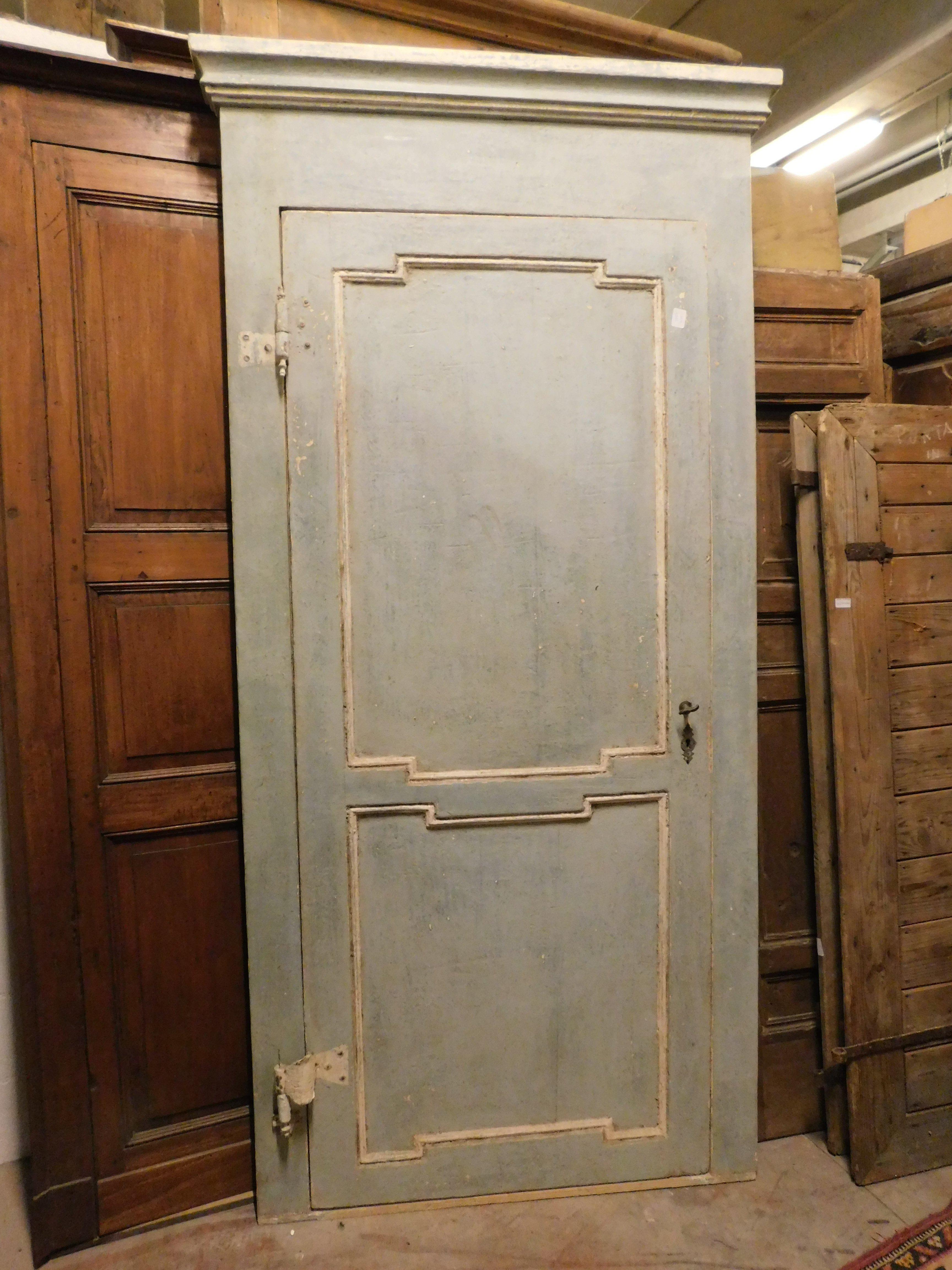 Antique interior door, Louis XVI, in solid wood lacquered in powder blue with original frame. Single-leaf door, with panels with painted white mouldings, double-sided, retains original irons with transverse gooseneck opening, with Pull opening, to