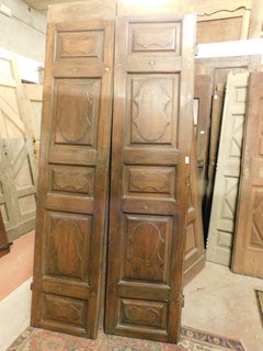Interior door in walnut wood, two leaves with carved panels, Italy