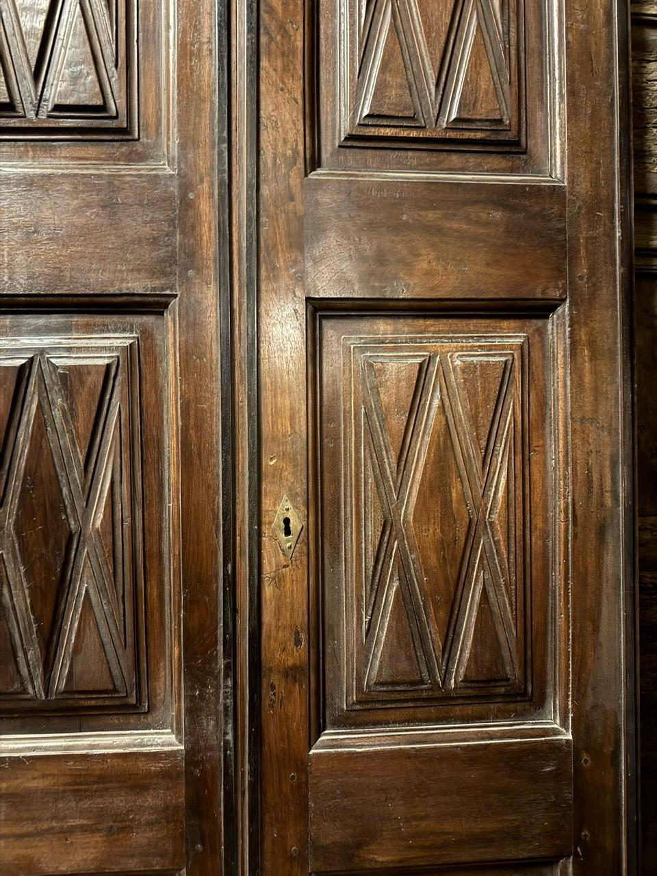 Hand-Carved Interior double-leaf walnut door, panels carved with geometric shapes, Italy For Sale
