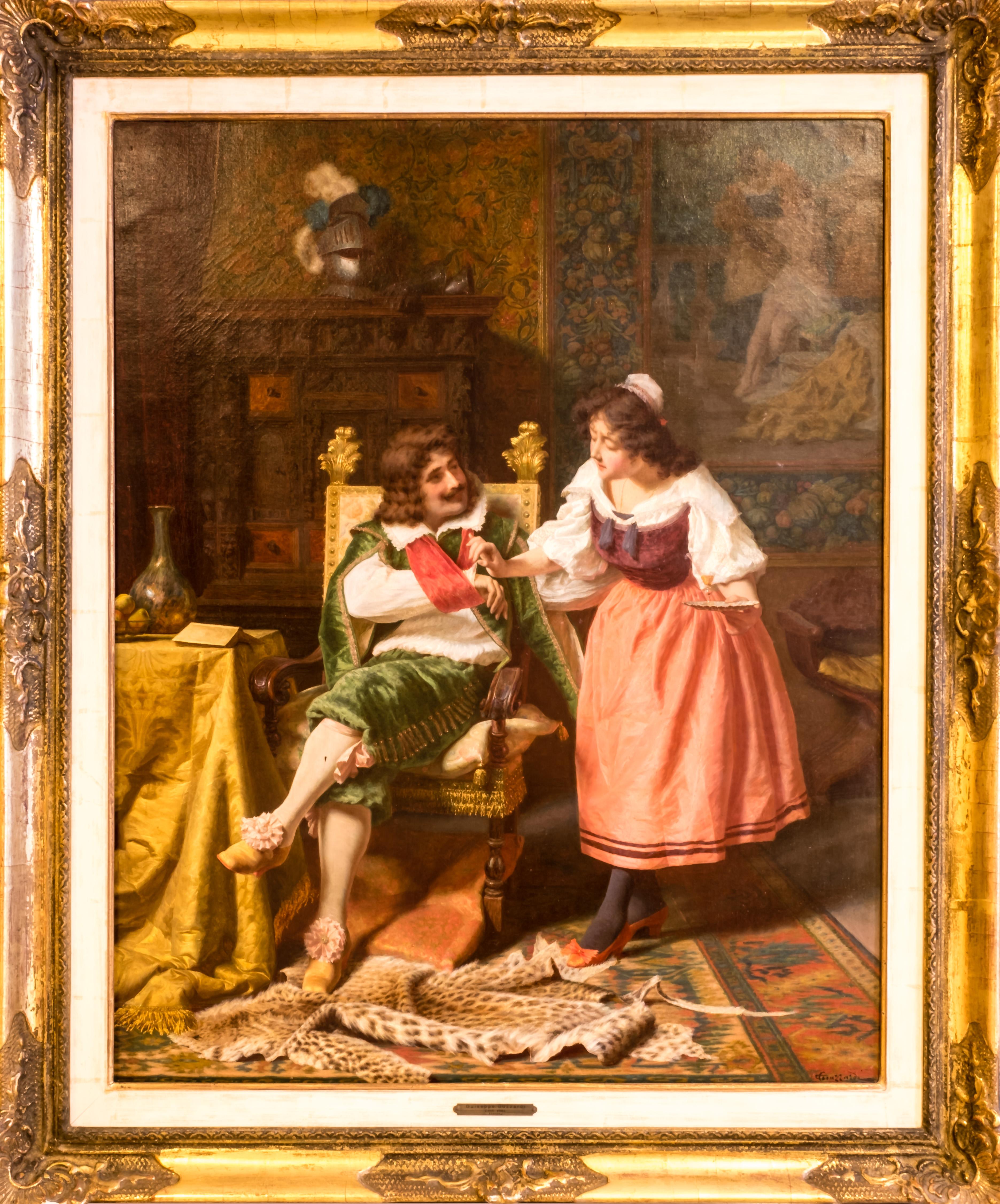 A 19th century genre painting by the colorful scene is set in a reading room, where the elegantly dressed nobleman, who recently fought in a battle (reference to the helmet and armor in the background), suffered an injury to his arm. The nurse,