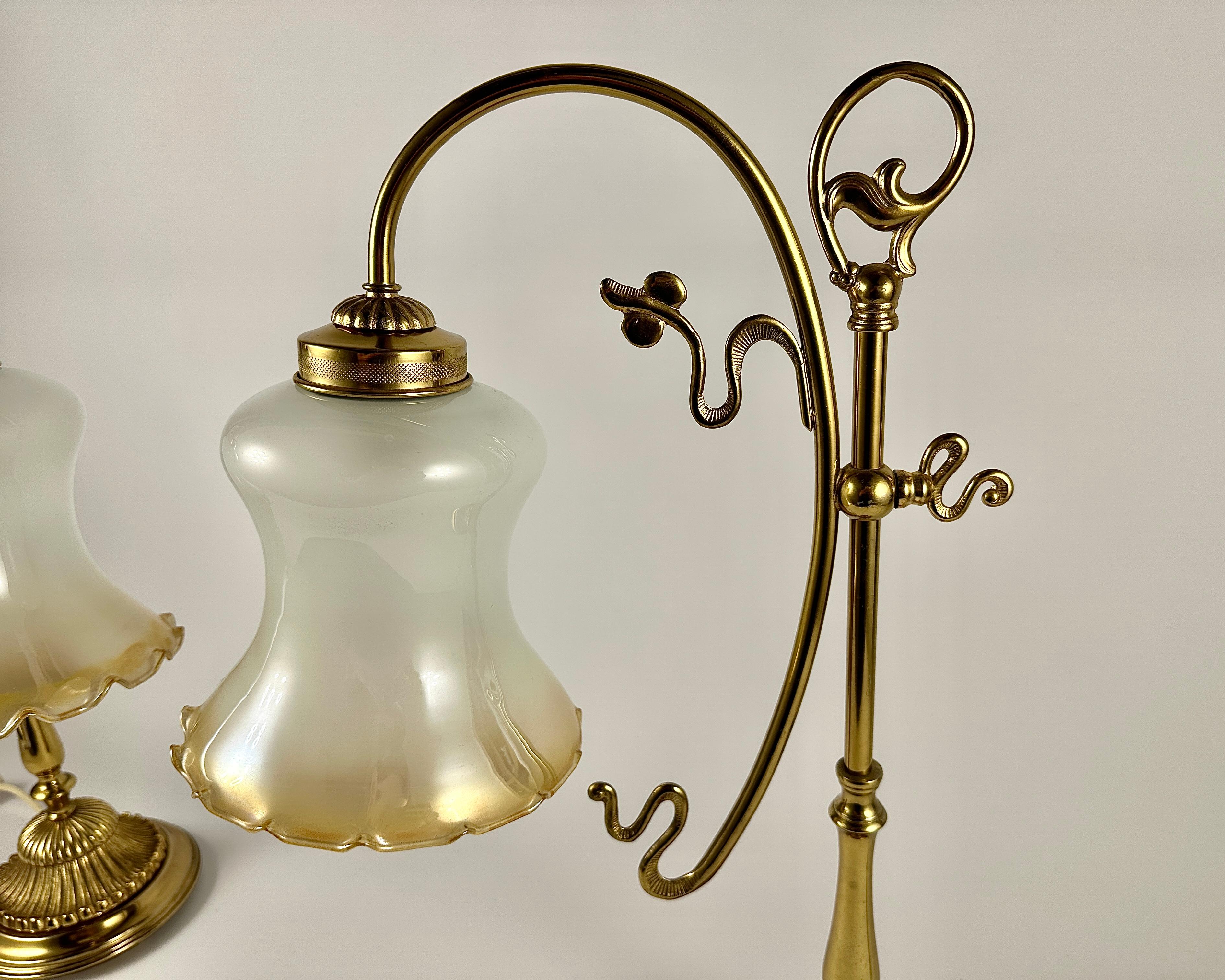 Pair of vintage table lamps with a frosted glass bell-shaped lampshade on an elegant, smoothly curved brass leg.

The stable round base ensures safety and comfort of use of the table lamp.

Glass and brass table lamp is a rich and sophisticated