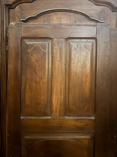 Interior walnut door with carved panels, Italy