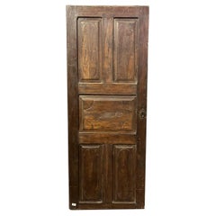 Interior walnut door with carved panels, Italy
