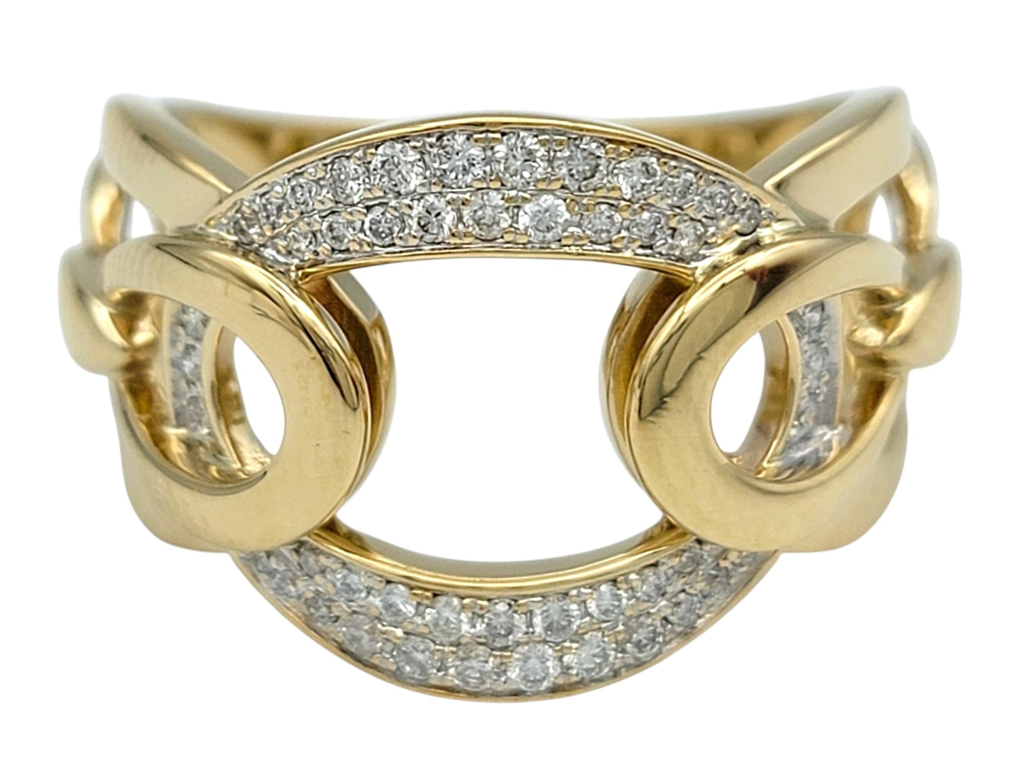 Ring Size: 6.75

This distinctive diamond ring is a bold and stylish expression of modern luxury. Crafted in 14 karat yellow gold, the design features a curved, open circle motif with diamond pavé along the sides. The asymmetry and dimensionality