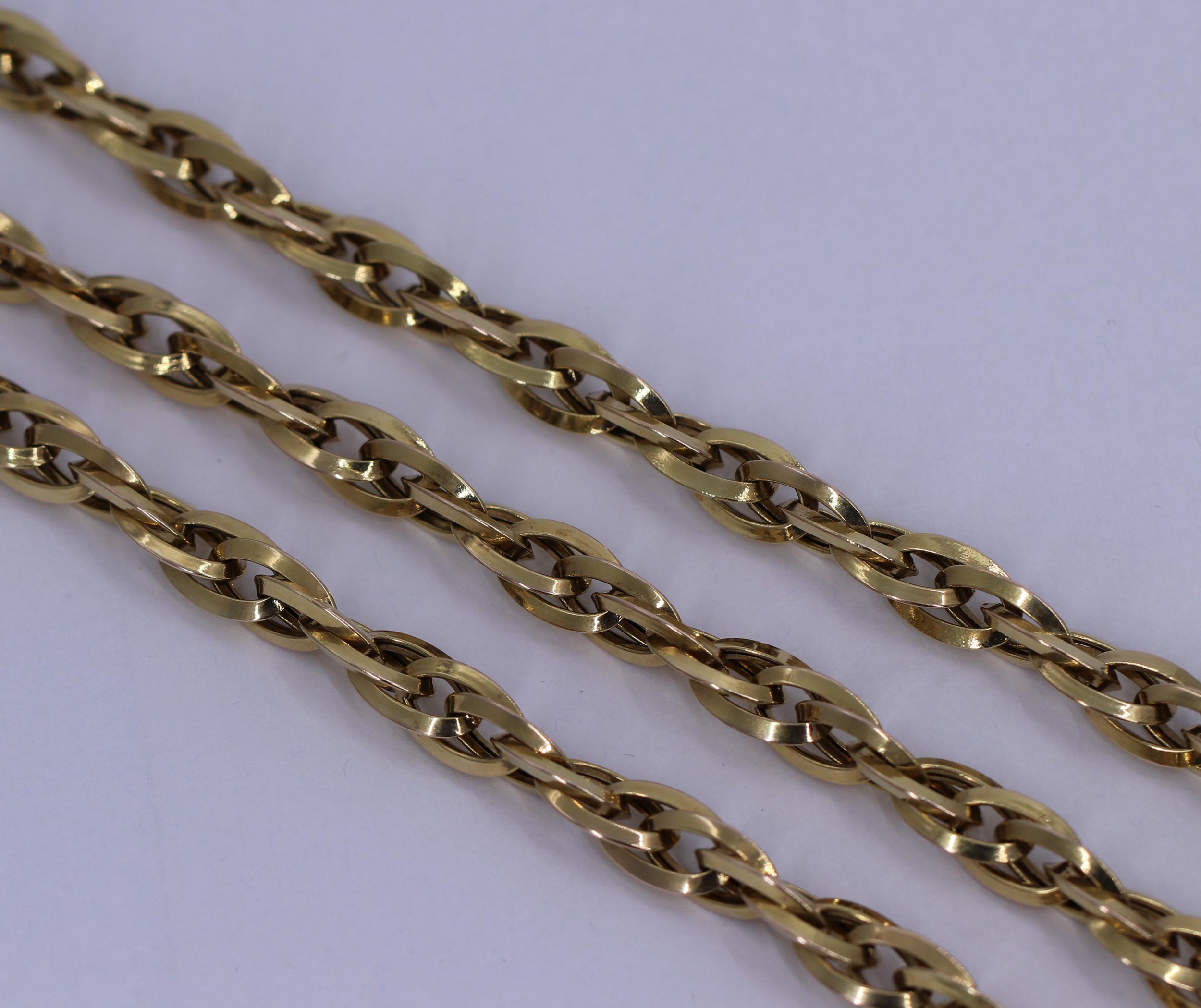 A ladies 14 karat yellow gold necklace measuring 36 inches long, and 3/8 of an inch wide. Made of interlocking links, it has a high polished finish, and a spiraling design. The chain features a good size lobster-claw clasp, making it easy to wear.