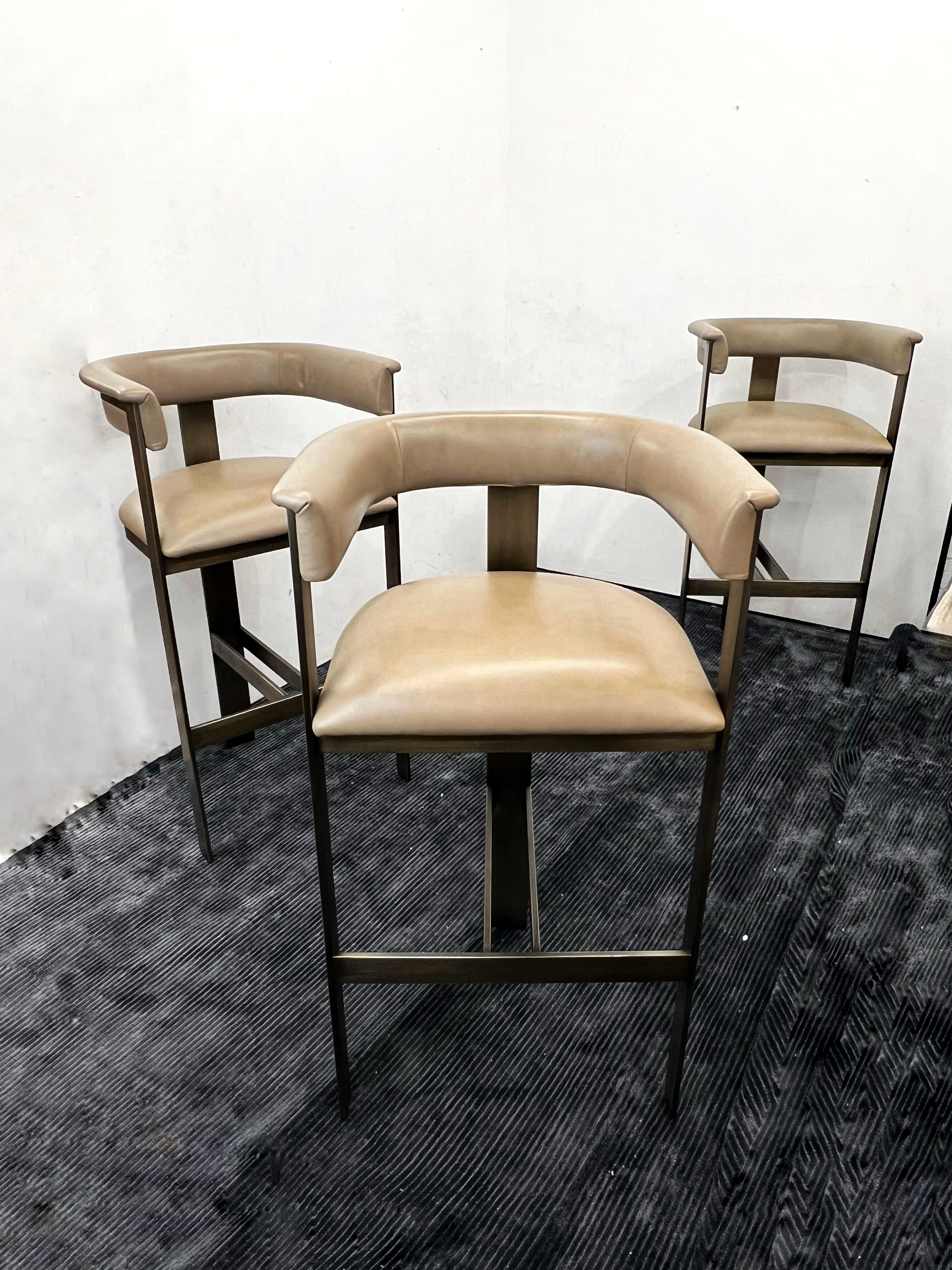 Retailed for $3,450+ Each 

In like new condition 

* Boasting an art moderne influence, the Darcy Bar Stool features a taupe leather seat and a streamlined stainless steel frame in an antique bronze finish.
* Genuine leather is a natural