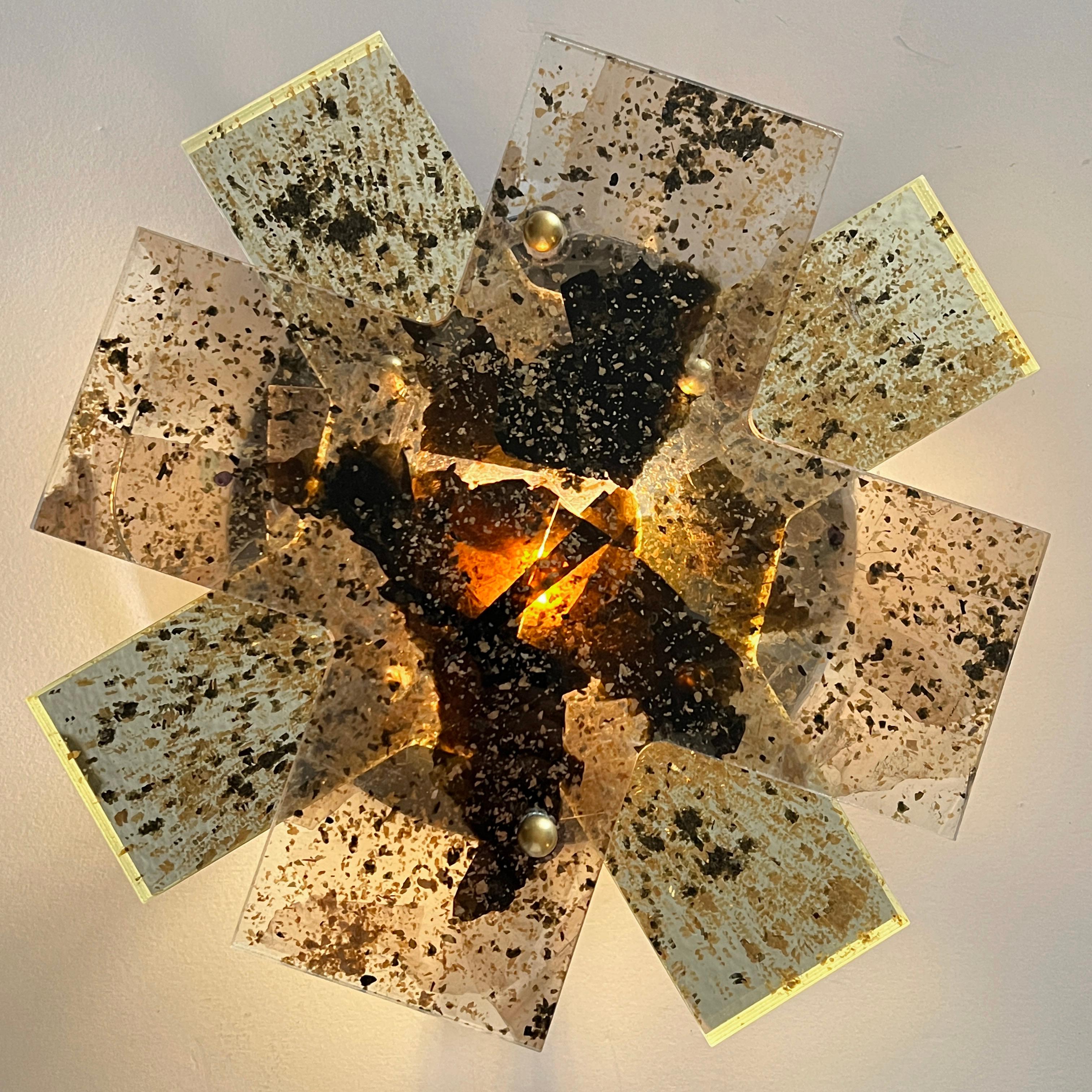 INTERMICA (NIMBUS LIGHT #2)
WALL SCONCE, 2023

InterMica® laminated Starphire and mirror with amber, gold & black mica flakes, LED bulb 14 x 14 x 2.75 in.

InterMica is an architectural specialty glass product, crafted from carefully selected flakes