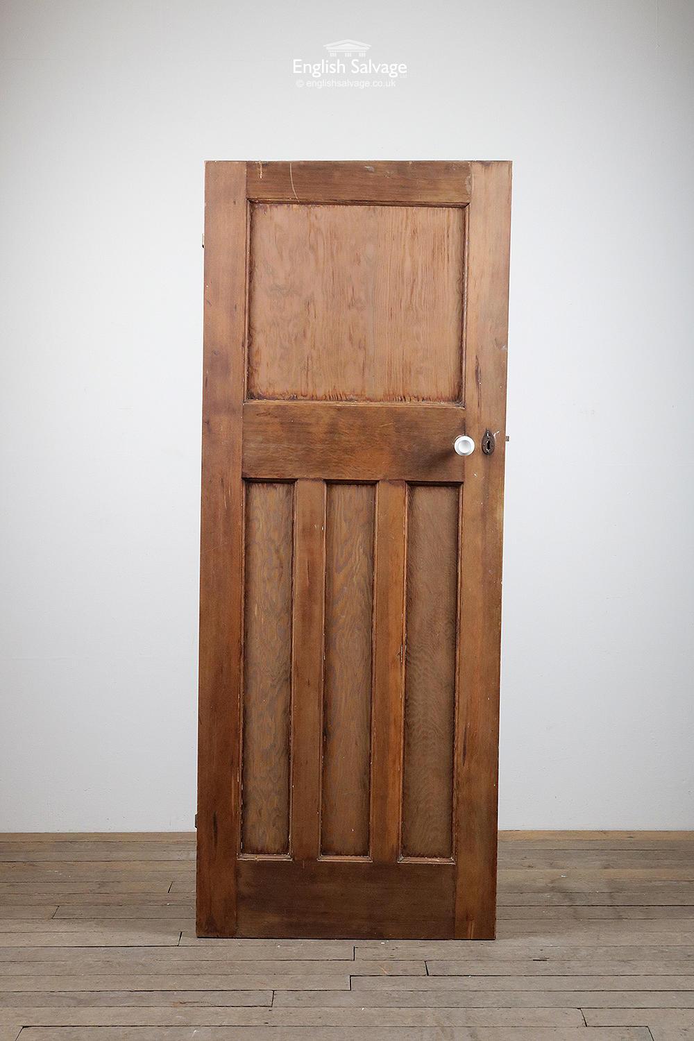 Reclaimed one over three internal door. Dark stained softwood with ply panels. Cut at the top and bottom, height varies from 194.6cm-195cm. Old lock and doorknobs, two barrel hinges.