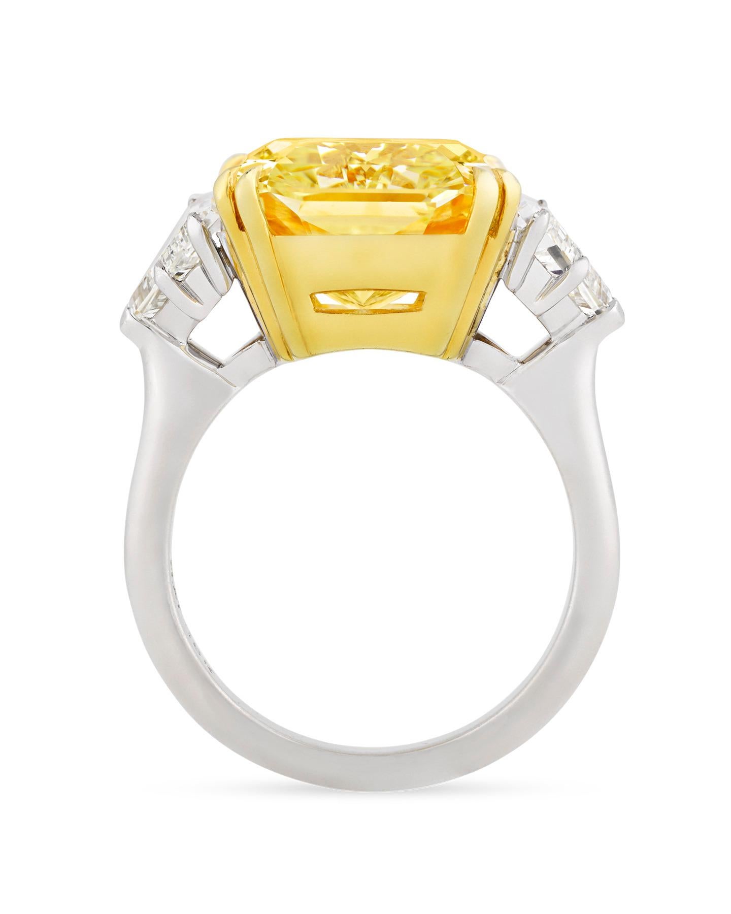 A dazzling 10.67-carat fancy yellow diamond is set in this impressive ring. The rare gemstone is certified by the Gemological Institute of America (GIA) as being an entirely untreated 