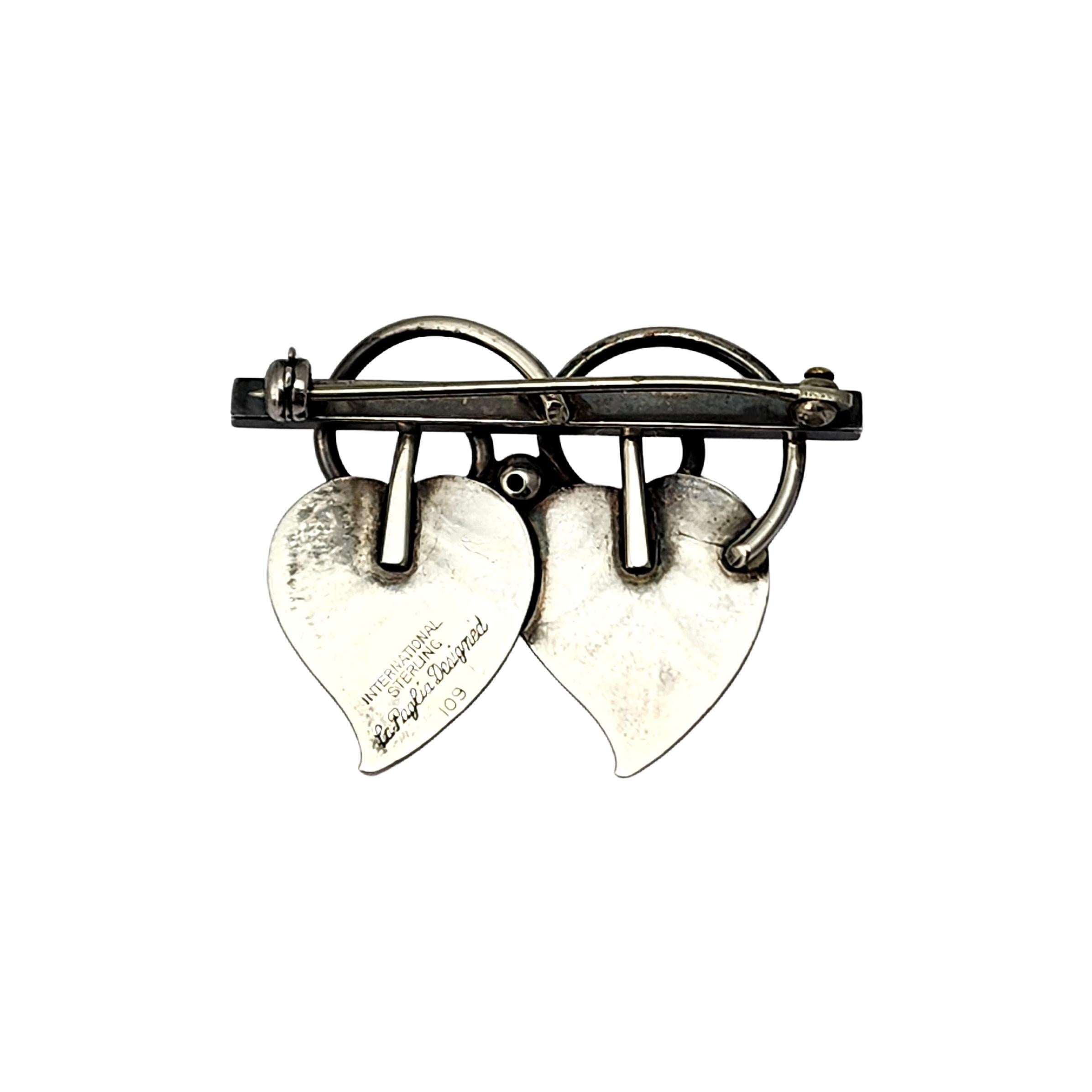 Vintage sterling silver double leaf pin/brooch designed by La Paglia for International Sterling, pattern #109.

This pin features 2 leaves detailed with black oxidized veins on a horizontal bar with swirl and bead accents..

Measures approx 1 3/4