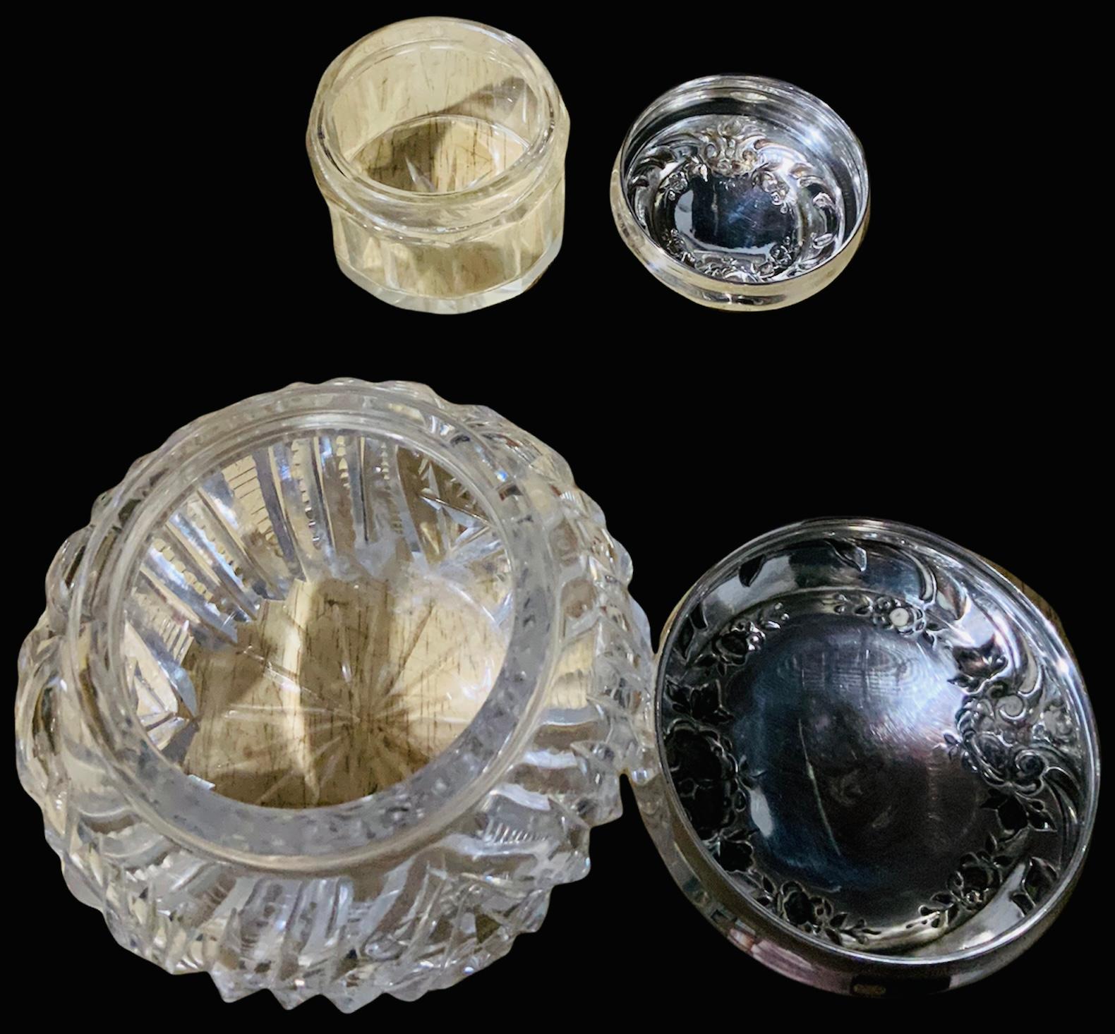 This is an International Sterling Company Vanity set. It depicts a repousse design of pansy flowers and foliage garlands, scrolls of leaves, plain scrolls and hearts. In the middle of these circular or oval garlands, there are the monograms with the