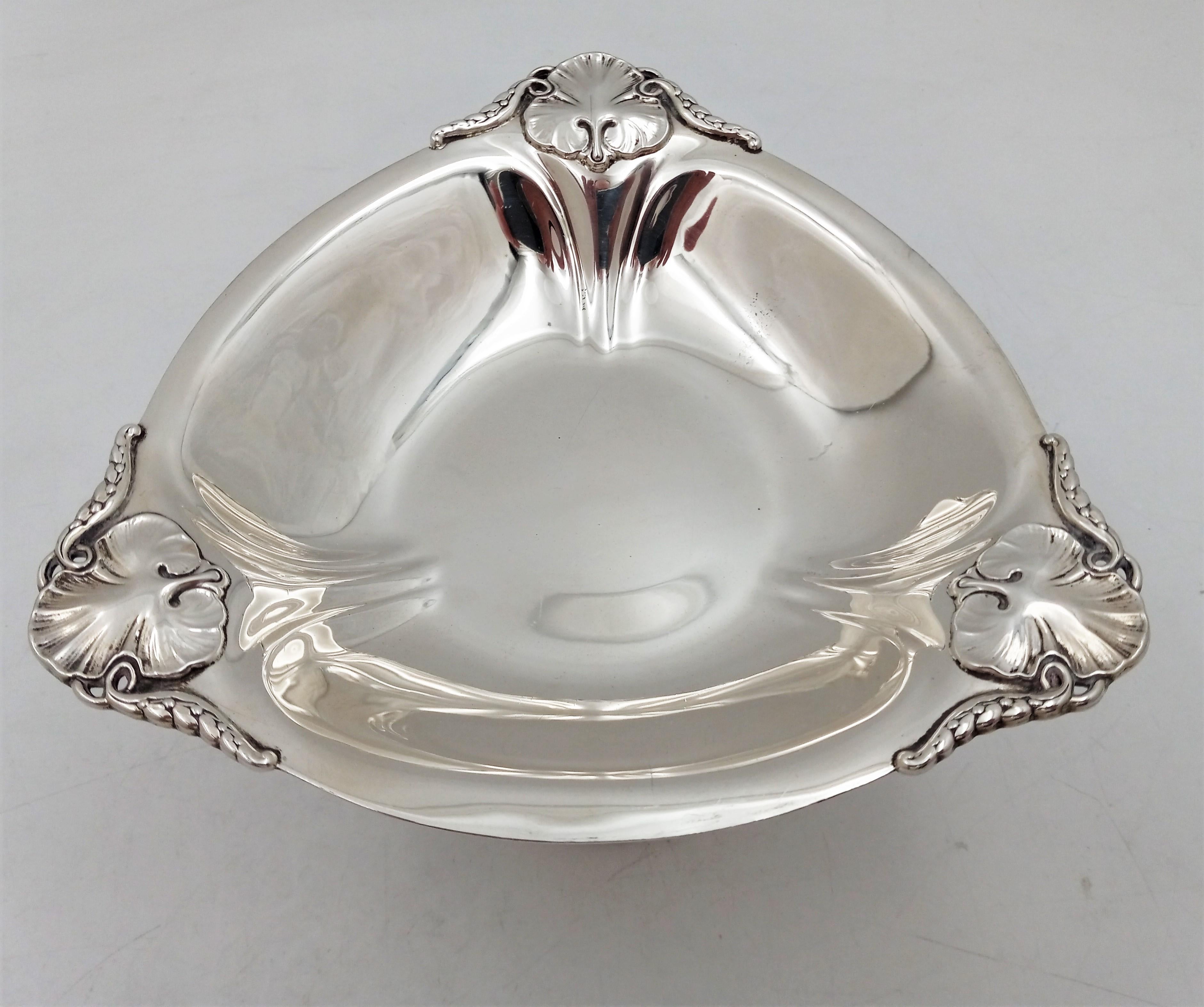 Sterling silver centerpiece bowl by International Sterling in Mid-Century Modern Georg Jensen style with exquisite floral and geometric-shaped designs. It measures 11 1/2'' in diameter by 4 1/2'' in height and weighs 30.1 troy ounces.

The