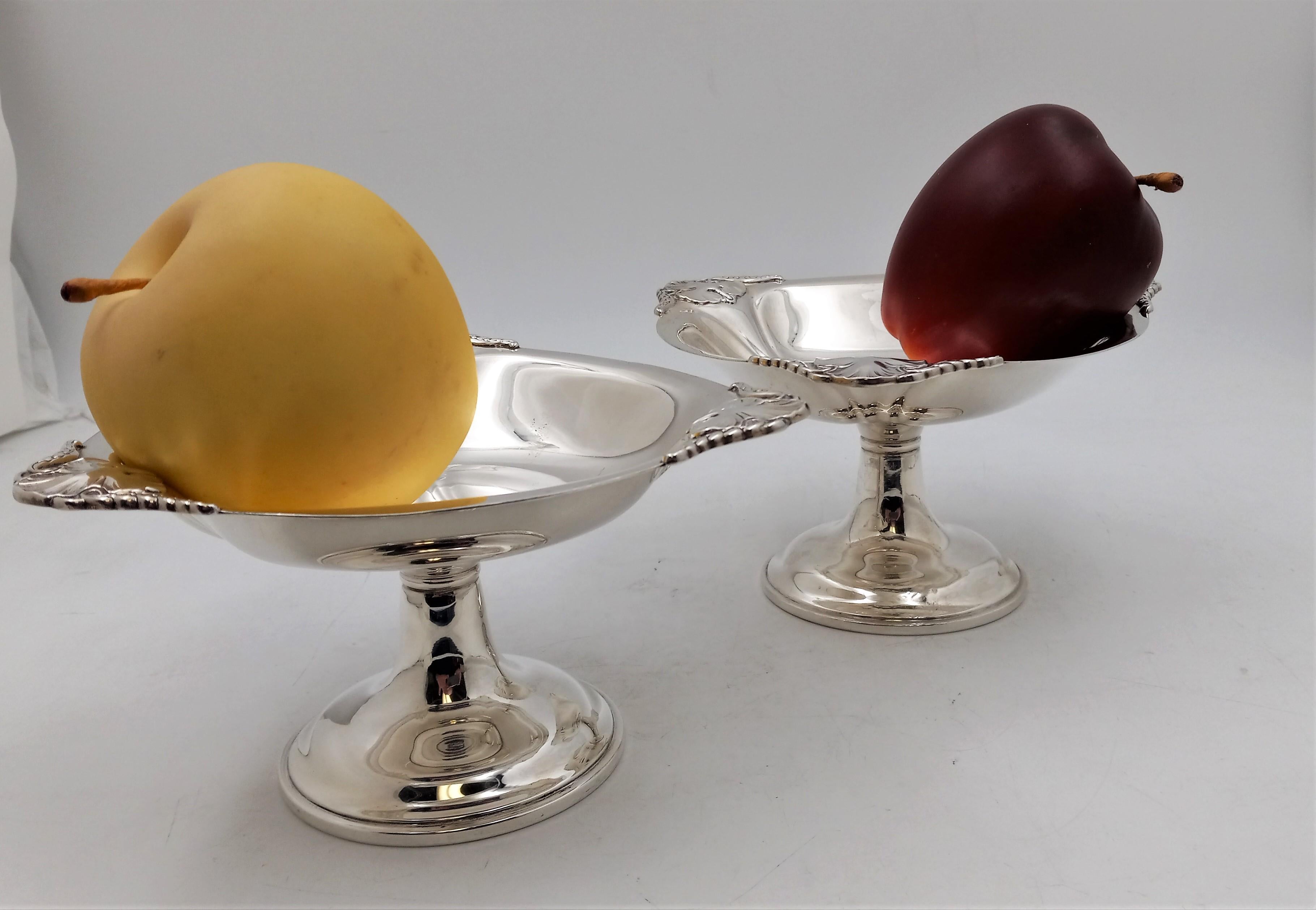 Pair of sterling silver stand dishes by International Sterling in Mid-Century Modern Georg Jensen style with exquisite floral and geometric-shaped designs. Each measures 7'' in diameter by 4'' in height and total weight is 22.1 troy ounces.

The