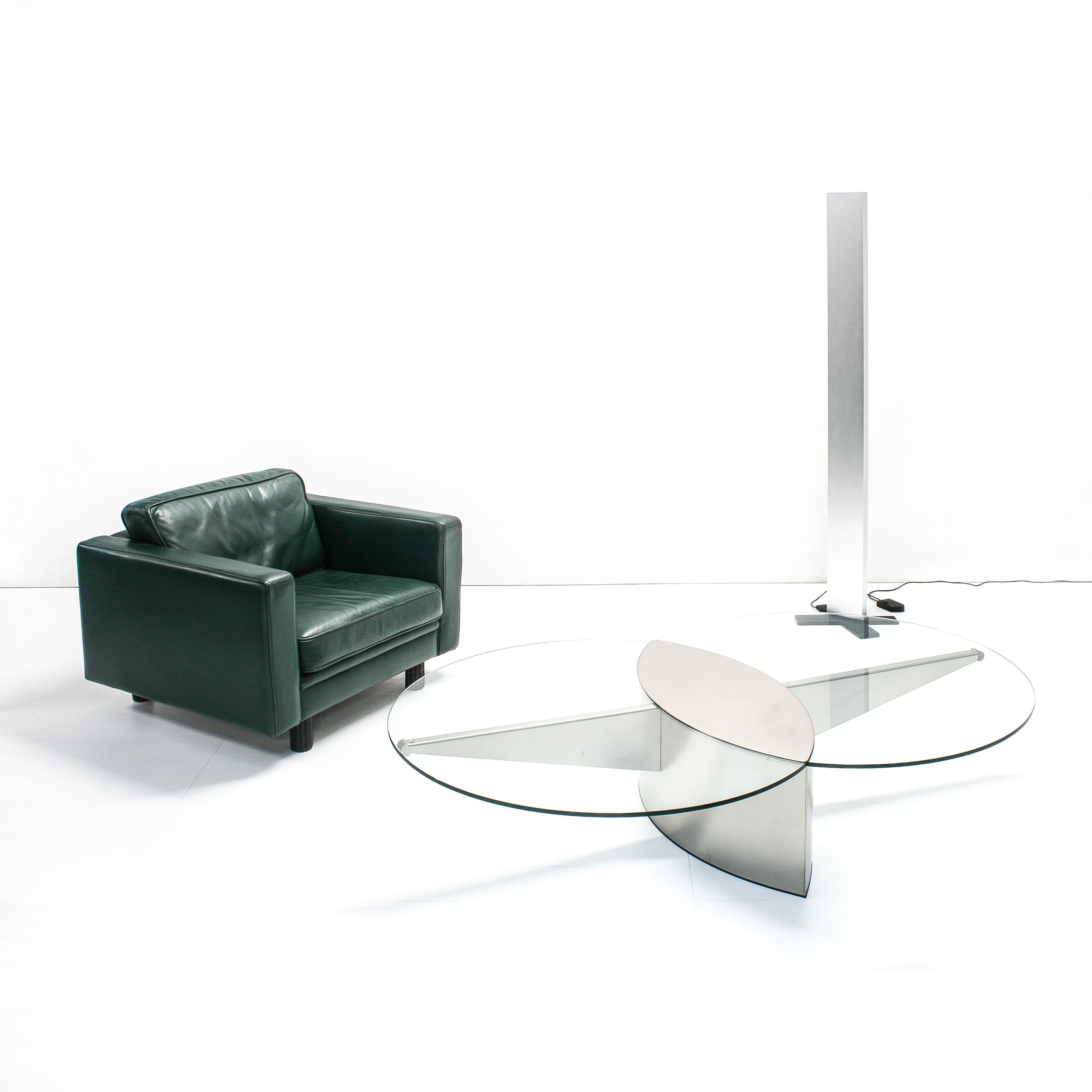 This coffee table was designed by the Belgian artist and furniture designer Koenraad Dewulf and produced by Belgo Chrom, Deinze. It consists of two intersecting glass circles on a symmetric stainless steel base.