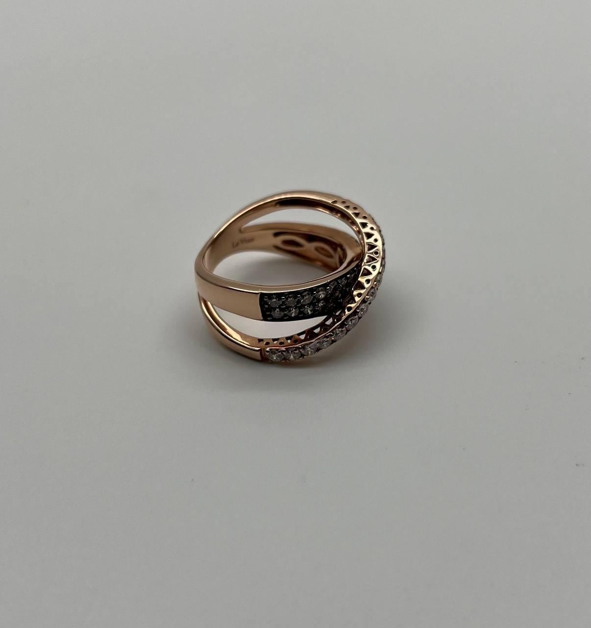 Discover the allure of our exquisite band ring, a true statement piece that captivates with its intricate design.

Crafted in luxurious 14K rose gold, this ring features a striking crossover pattern adorned with pavé-set champagne brown and white