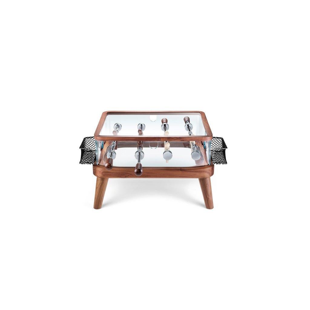 Intervallo foosball coffee table, designed by Adriano Design and manufactured by Teckell, features a solid milled Canaletto walnut structure. Players: one team Canaletto walnut, the other ash wood. Shell perimeter in 15 mm thick crystal. The