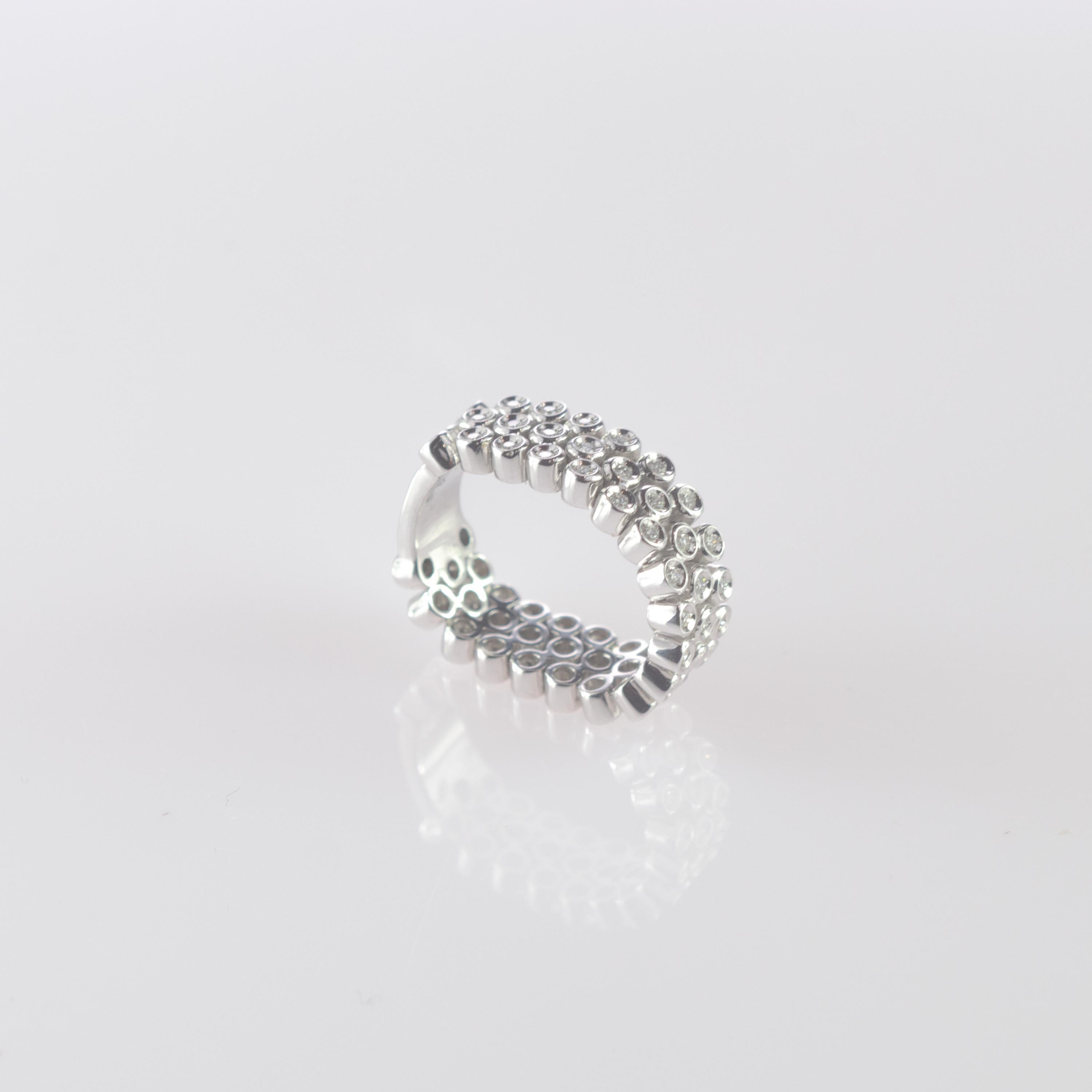 Rare and magnificent flexible band ring. 0.85 diamond carats helded in a 18 karat white gold structure. The ring has an exquisite and modern design that holds 57 stunning diamonds in a brilliant shape.
 
At intini all our jewels have a personality