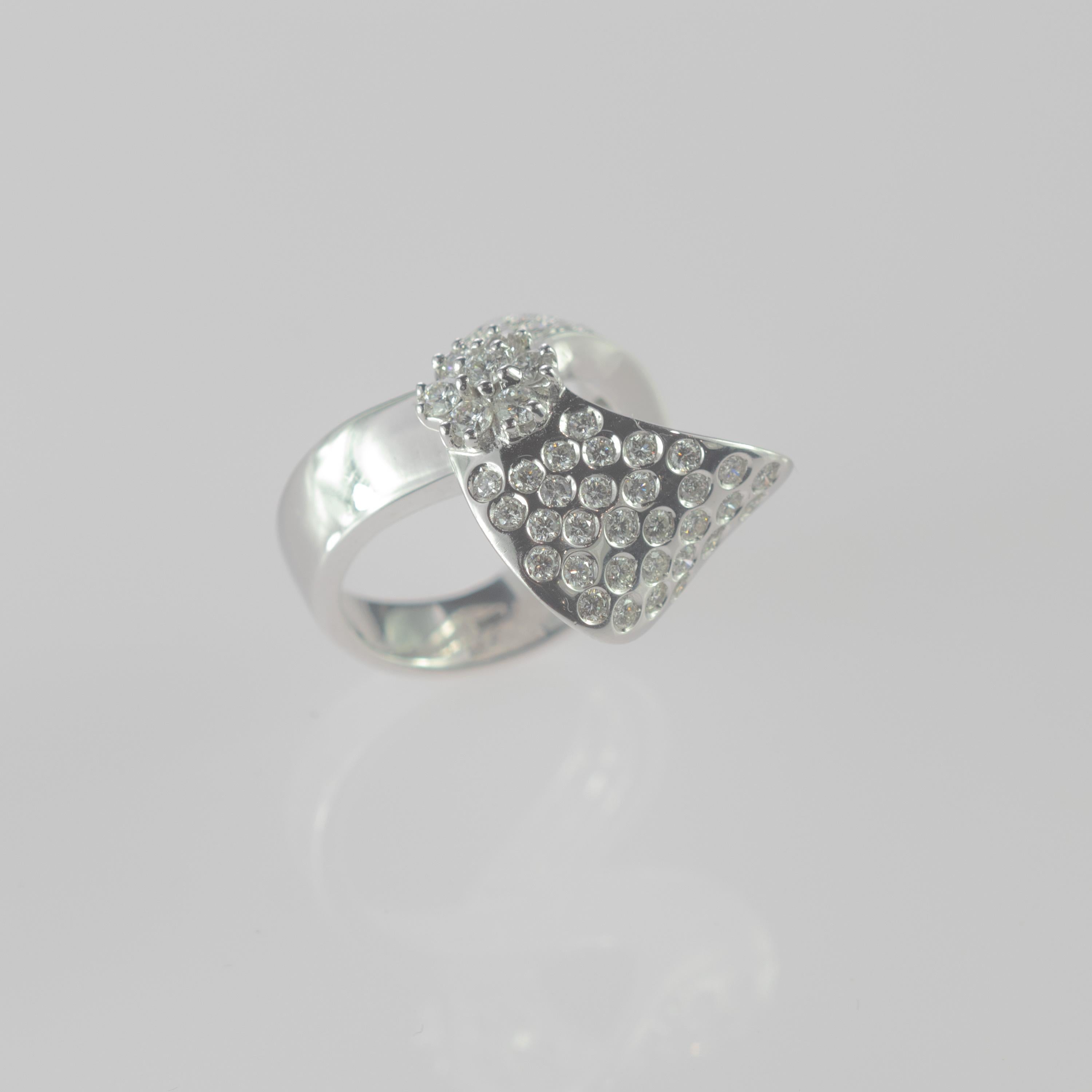 Mysterious and mystical italian design with 1.5 carat square brilliant cut diamond shape setted in smooth 18 carat white gold curves. This design involves the soft movement of the materials creating an unequal curved piece of jewelry beautifully