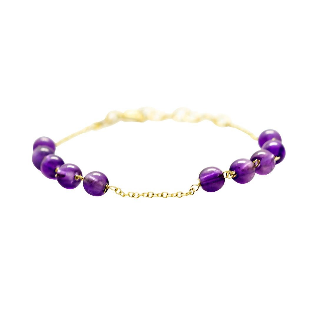 Marvellous bracelet starring natural amethyst beads, for a bright charm of uniqueness. Luminous jewel with natural precious jewellery on elegant 18 karat yellow gold setting.

Amethyst is marked as the stone for the month of February. Amethyst is