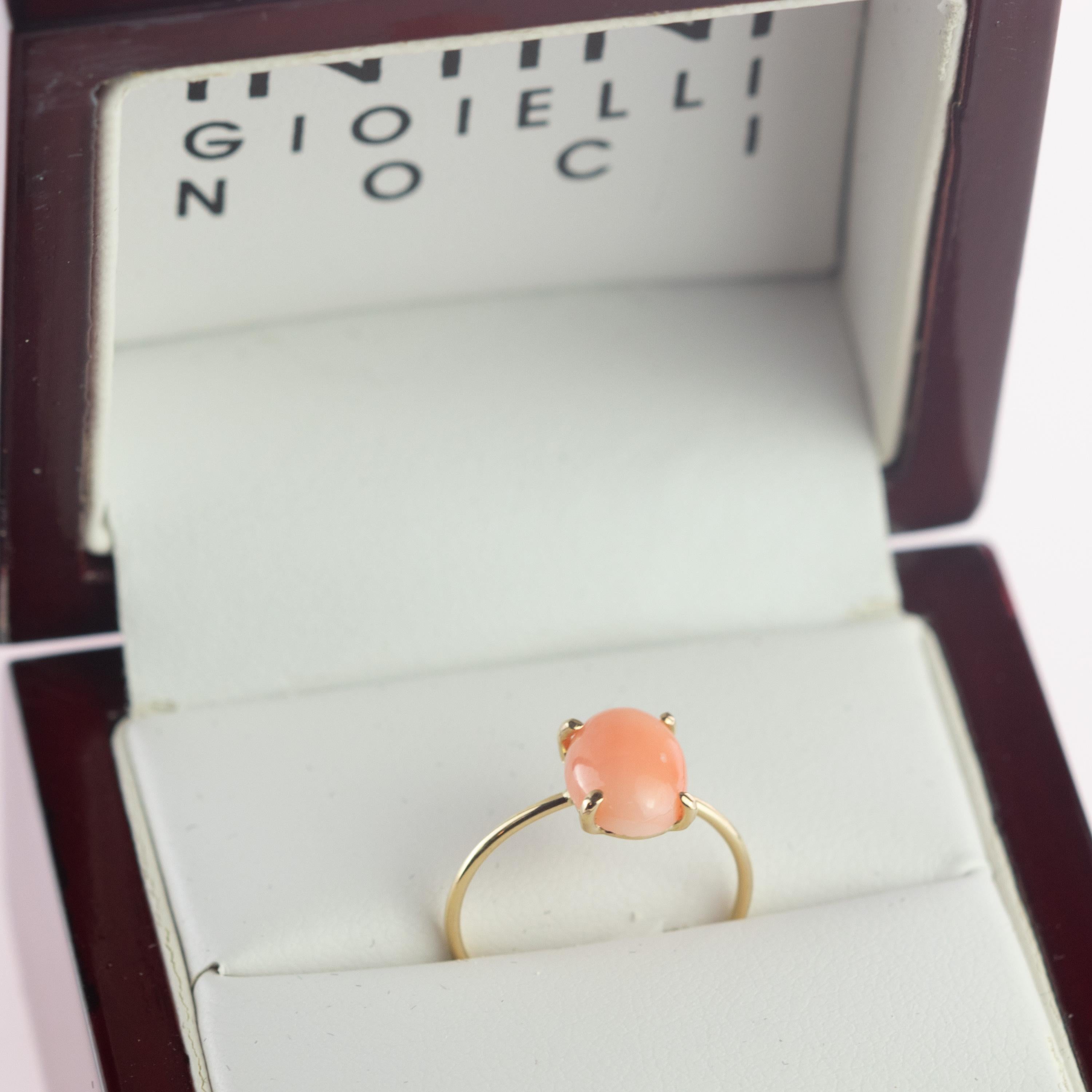Oval Cabochon solitaire cocktail ring design, with deep pink colour. Handmade 2 carats natural coral stone on 18 karat yellow gold ring inspired by the joy of summer sunsets. With a perfect size, it will fill with your daily elegant outfits. Made in