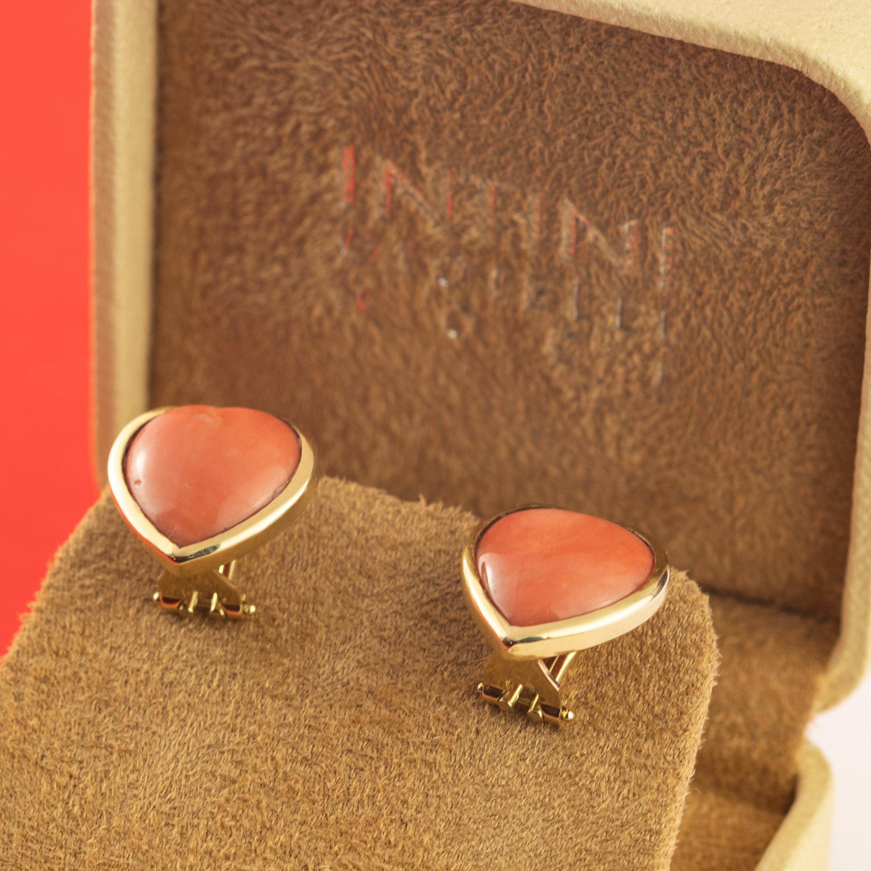 Sweet and extraordinary stud earrings modeled in a heart and bold shape of salmon natural coral surrounded with 18 karat yellow gold that creates a unique and romantic clip on design. Italian craftsmanship adorning the perfect stud earrings for a