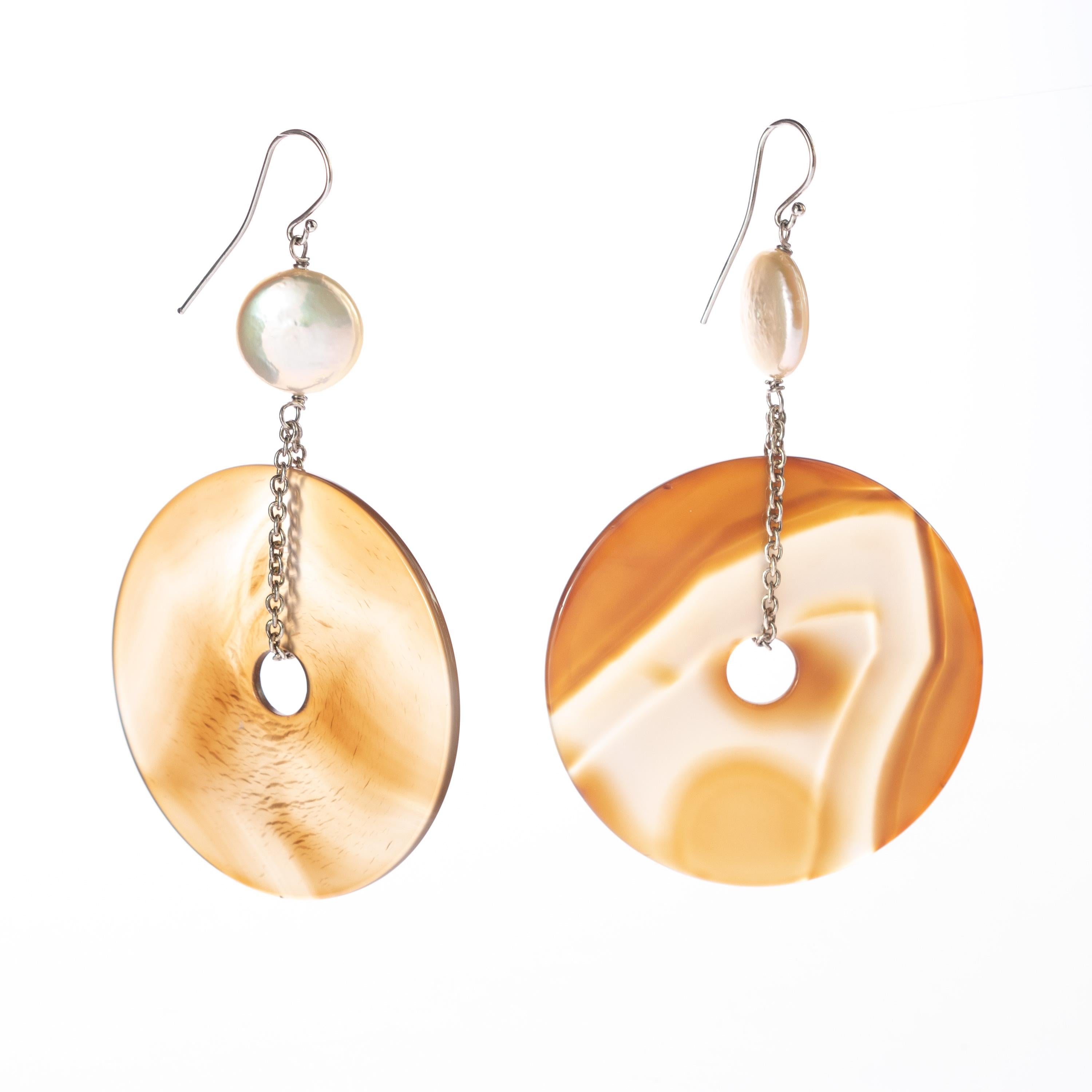 Circular brown donut-shaped agate with a sand-colored shade. A unique and modern piece designed with a vintage and elegant style. Dangle and long earrings with a delicate 925 sterling silver chain holding a round pearl.

Inspired in one of the