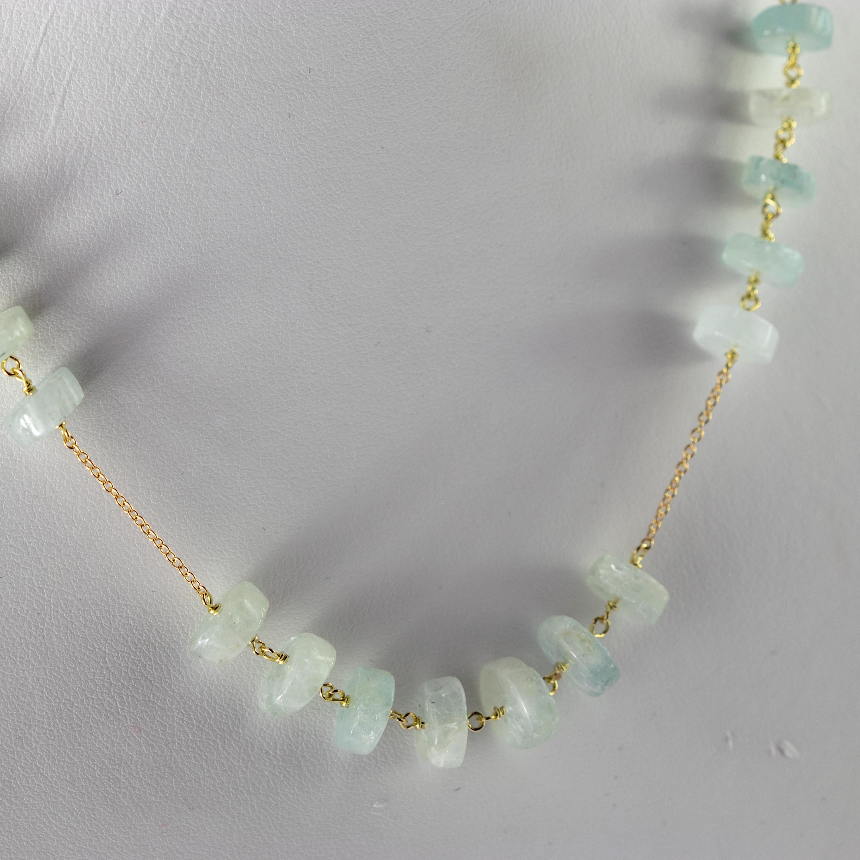 Magnificent natural precious jewellery on elegant 9 karat yellow gold setting. Marvellous necklace starring pure aquamarine raw rondelles, for a bright charm of uniqueness.
 
An elegant touch of glamour at your fingertips. Let yourself be tempted by