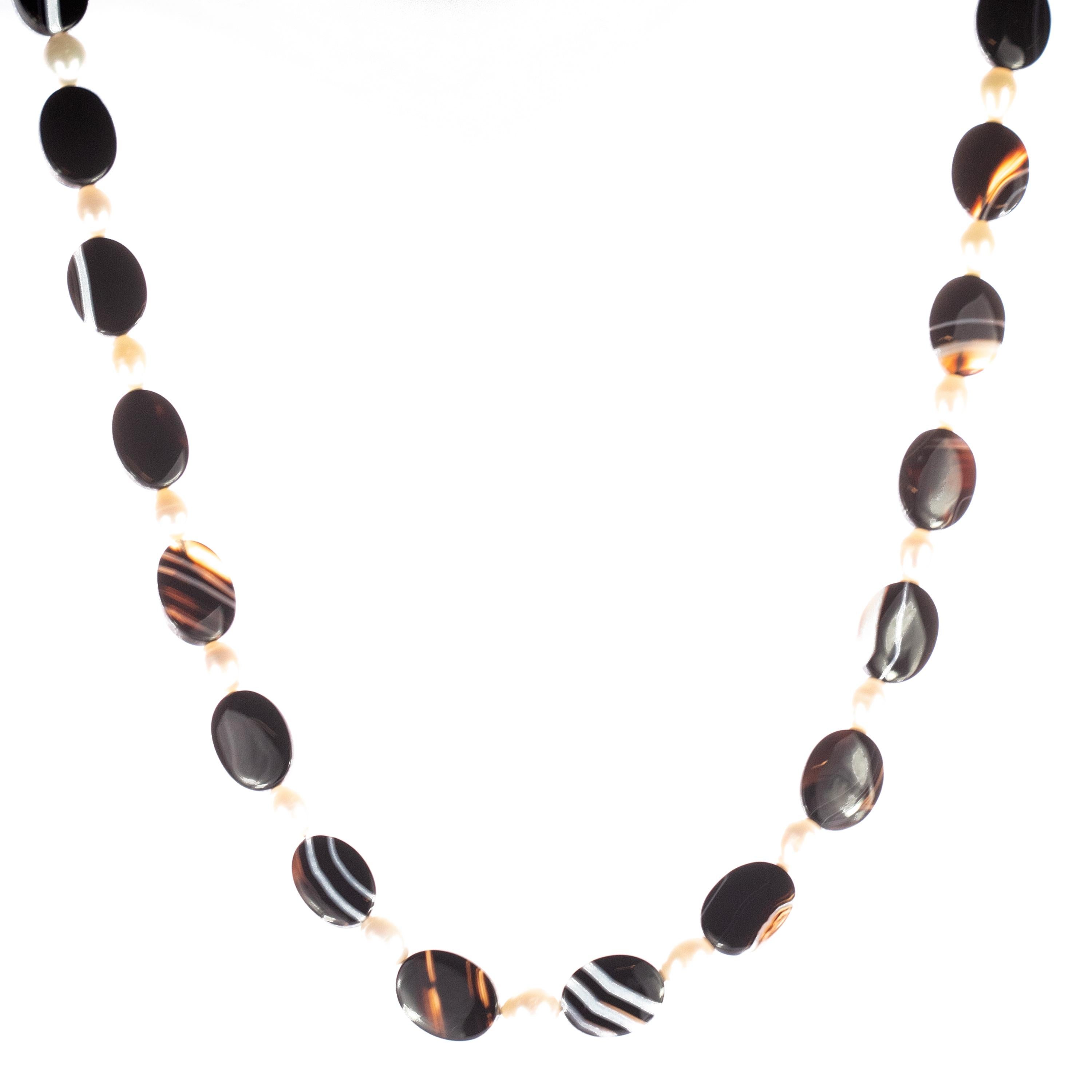 Rare and stunning spindly necklace with a strand of faceted black and white agate. Strapped gemstones mixing the two basic colors. Timeless, modern and magnificent design with fabulous beaded and boho touch that gives an extraordinary look for any