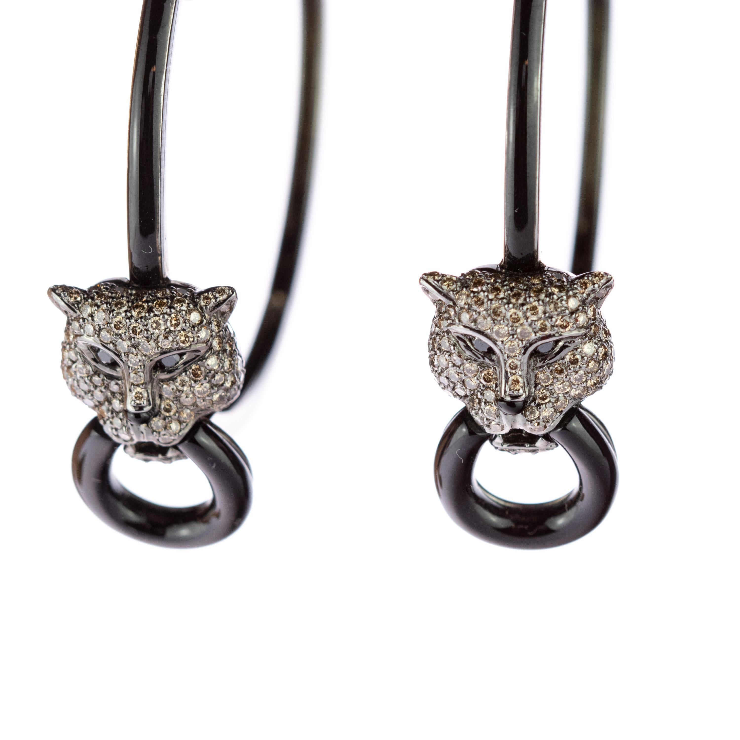 Enjoy the absolutely beauty of this resplendent and marvellous hoop earrings. 2.4 carat diamonds in a tiger, jaguar cat or panther shape with deep black eyes and round nose. The animal have a round donut in its mouth and is posed in a big black