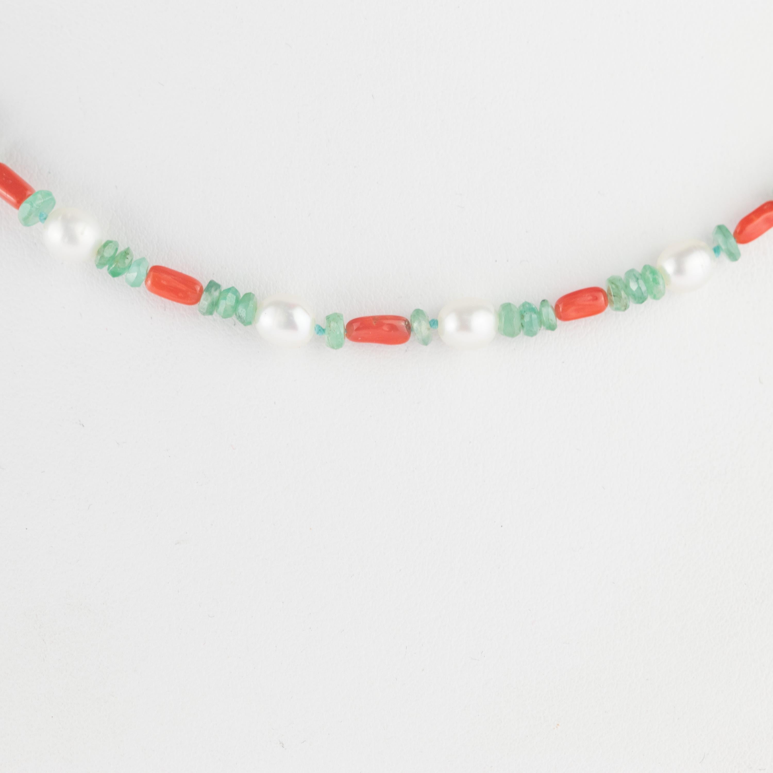 Marvellous necklace starring emeralds, coral and pearls for a bright charm of uniqueness. Luminous jewel with natural precious jewellery on elegant 14 karat yellow gold setting. 
 
Ancient beliefs say that we should always carry jewels with various