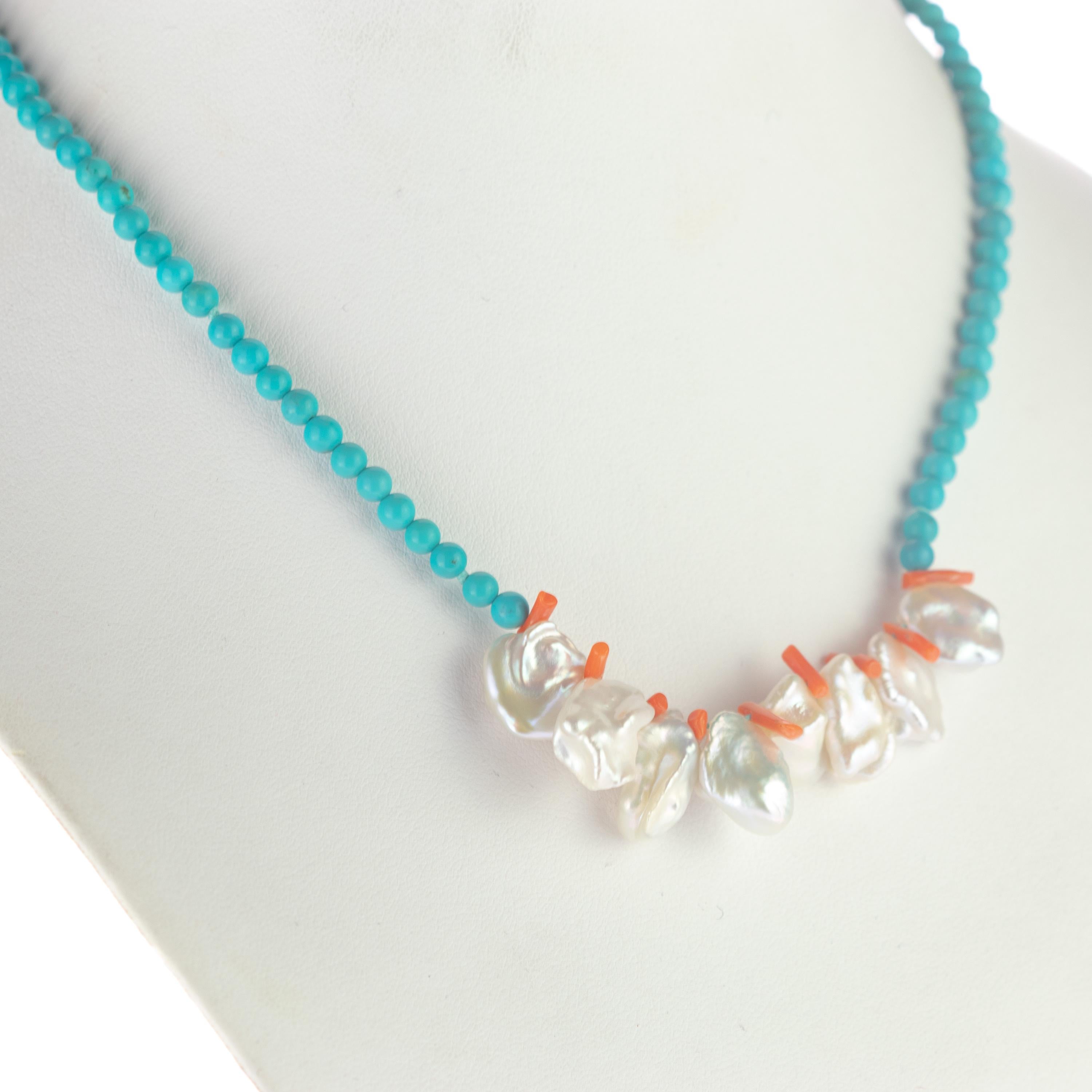 A delicate strand of turquoise beads with central mother of pearl and coral chips necklace. Immerse yourself in the beauty of this uniquely designed necklace with natural stones full of life and color. A hawaiian inspirational jewel which will match