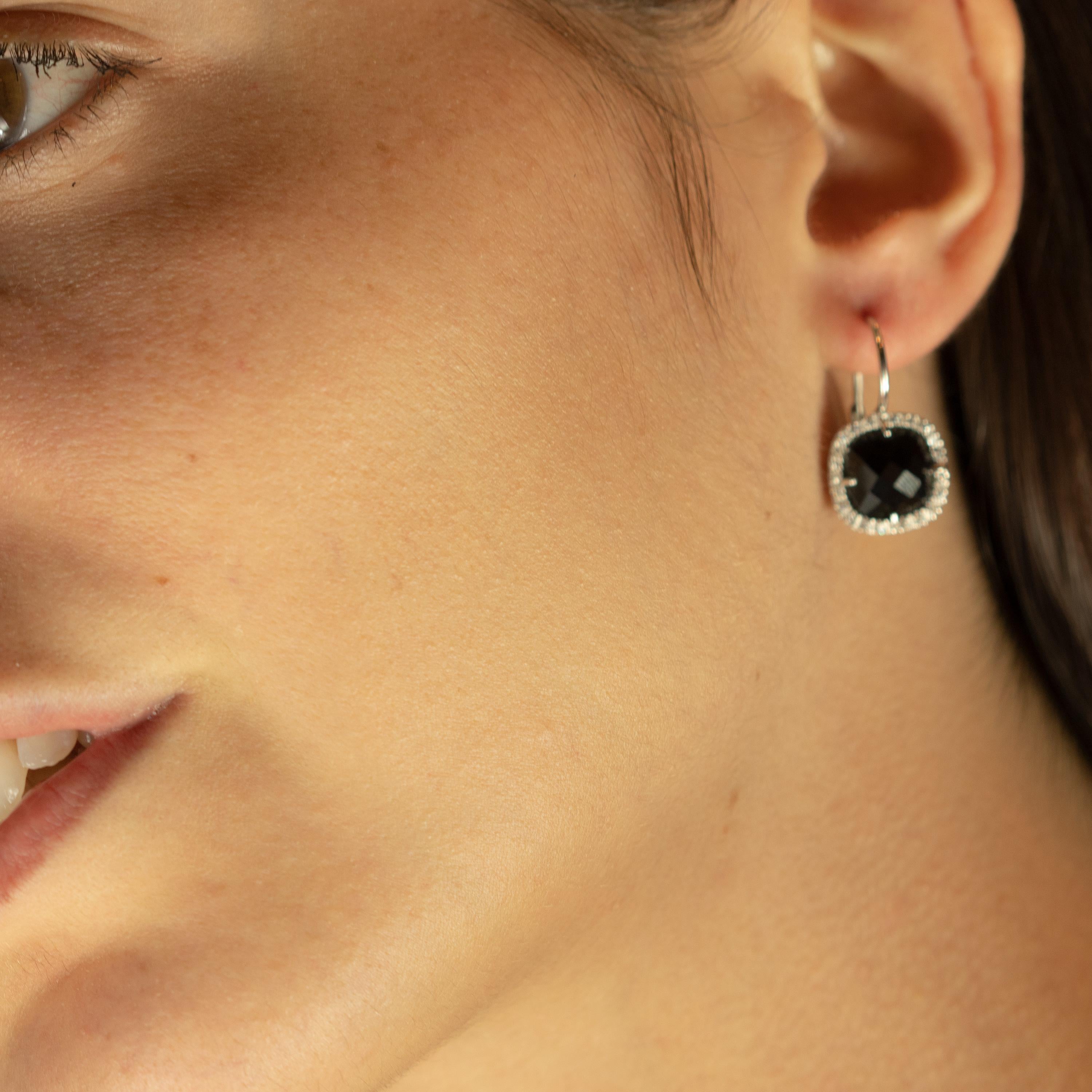 Vintage clip-on style earrings featured by a beautiful black square cushion onyx delicately surrounded by 0.9 carat diamonds. The stunning gems are setted in 18 karat white gold ear clips exceptionally priced. Black and white are the colors of