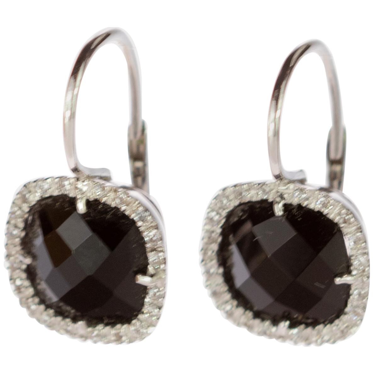 Vintage clip-on style earrings featured by a beautiful black square cushion onyx delicately surrounded by 0.9 carat diamonds. The stunning gems are setted in 18 karat white gold ear clips exceptionally priced. Black and white are the colors of