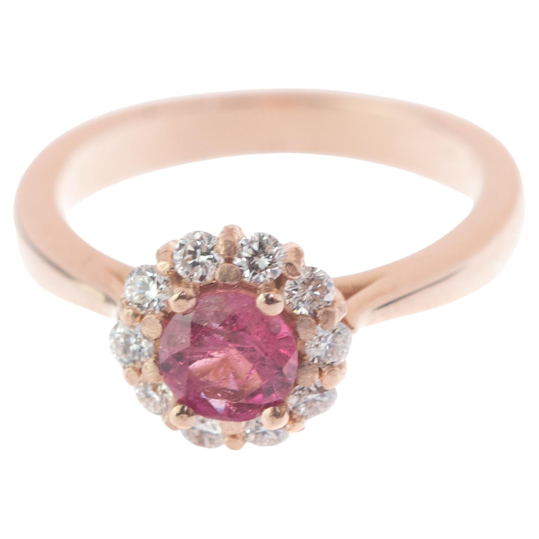 A stunning Diana Ring style jewel. An oval tourmaline enhanced by 18 karat pink / rose gold with diamonds. 

• 18 karat pink / rose gold (750 stamp) 4.6 g
• Tourmaline total 0.6 carats
• Diamonds 0.57 carats, G/H colour, VS clarity
• Size 5 2/3 US,