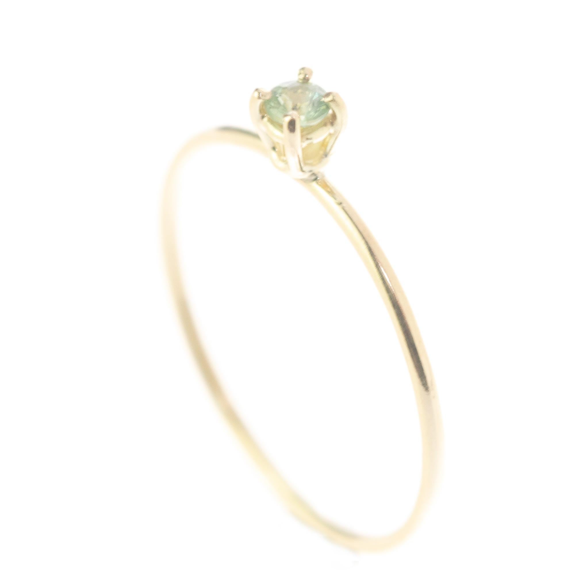 Signature INTINI Jewels green sapphire jewellery. Modern and elegant ring design in 14k yellow gold with an brilliant cut with tiny griffes sormounting the ring.

The meaning of green sapphires is that it symbolizes tranquility and calmness. A green