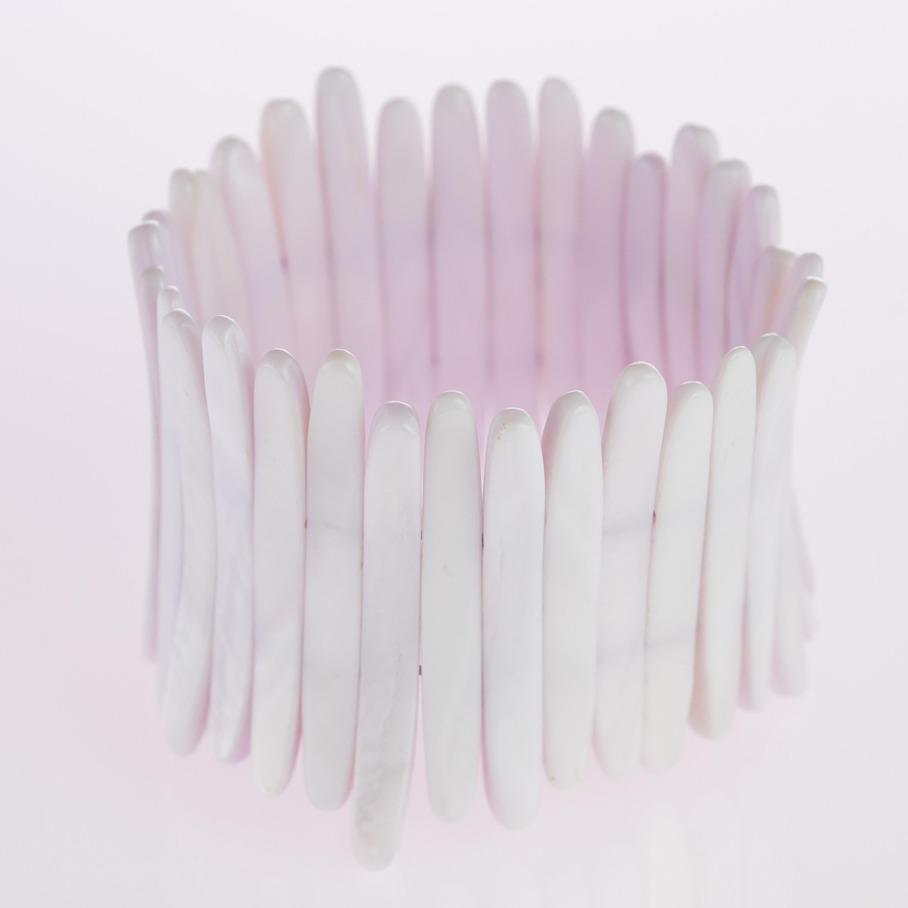 Iconic and stunning lilac mother of pearl stretch beaded iconic bracelet. Full of design and beauty for a perfect cocktail night.

The mother of pearl is an organic-inorganic composite material; it is the inner shell layer, and makes up the