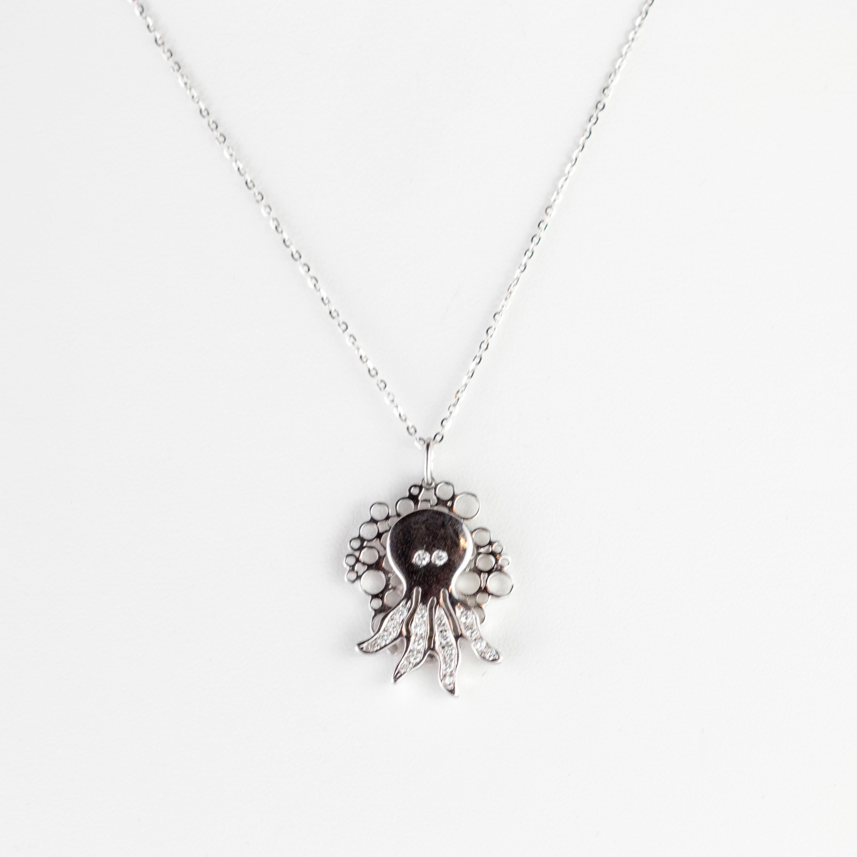 Elegant and minimalistic one-of-a-kind necklace with a carved octopus  pendant. Handmade jewels that highlight a magnificent creature with 2 diamond eyes and 4 tentacles full of 0.3 carat diamonds. Setted in a woven evoking the splendid sea corals
