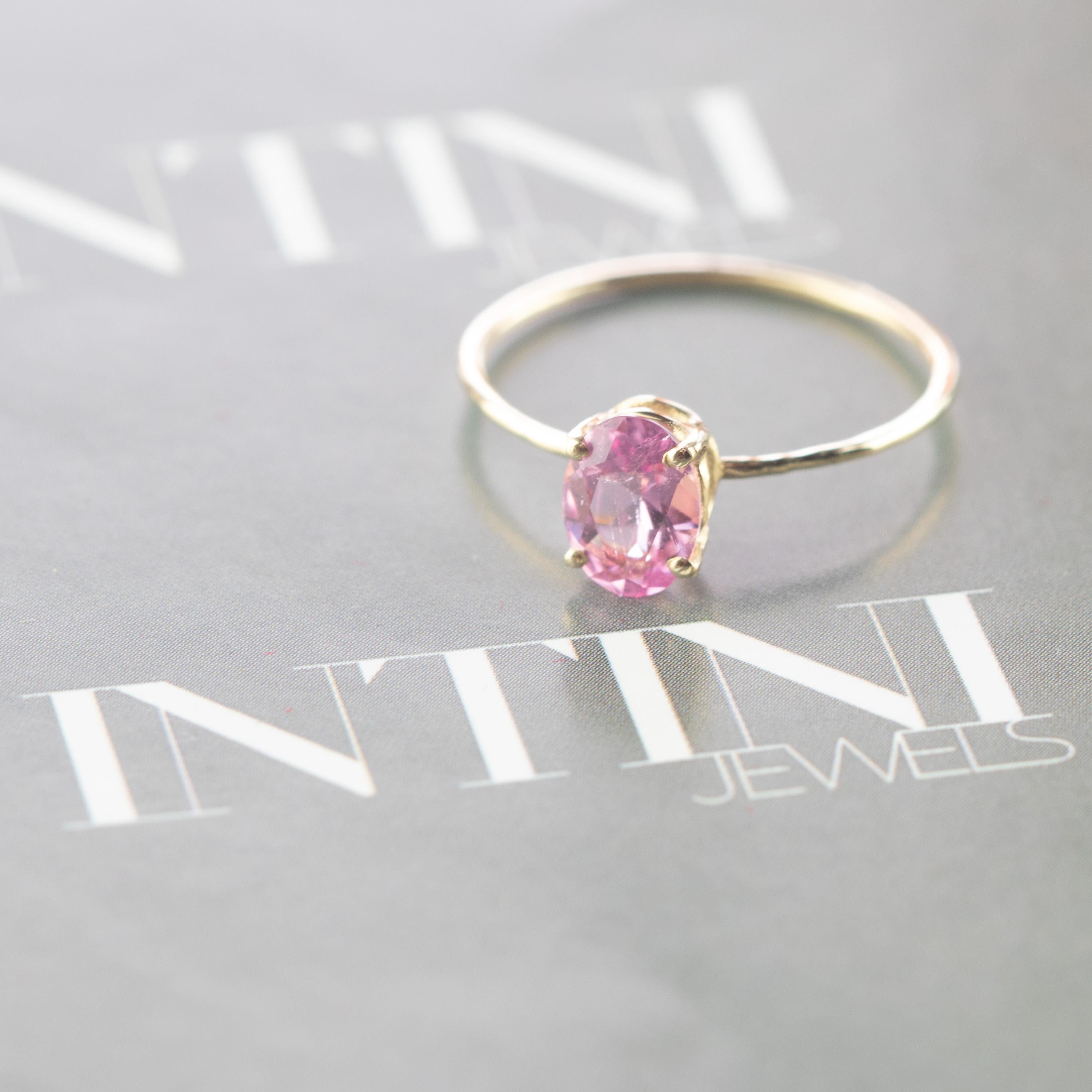 Signature INTINI Jewels Tourmaline jewellery. Modern and elegant midi ring design in 9k yellow gold with an oval cut with tiny griffes sormounting the ring. Oval, cocktail and handmade ring.

Pink Tourmaline graces the month of October with its