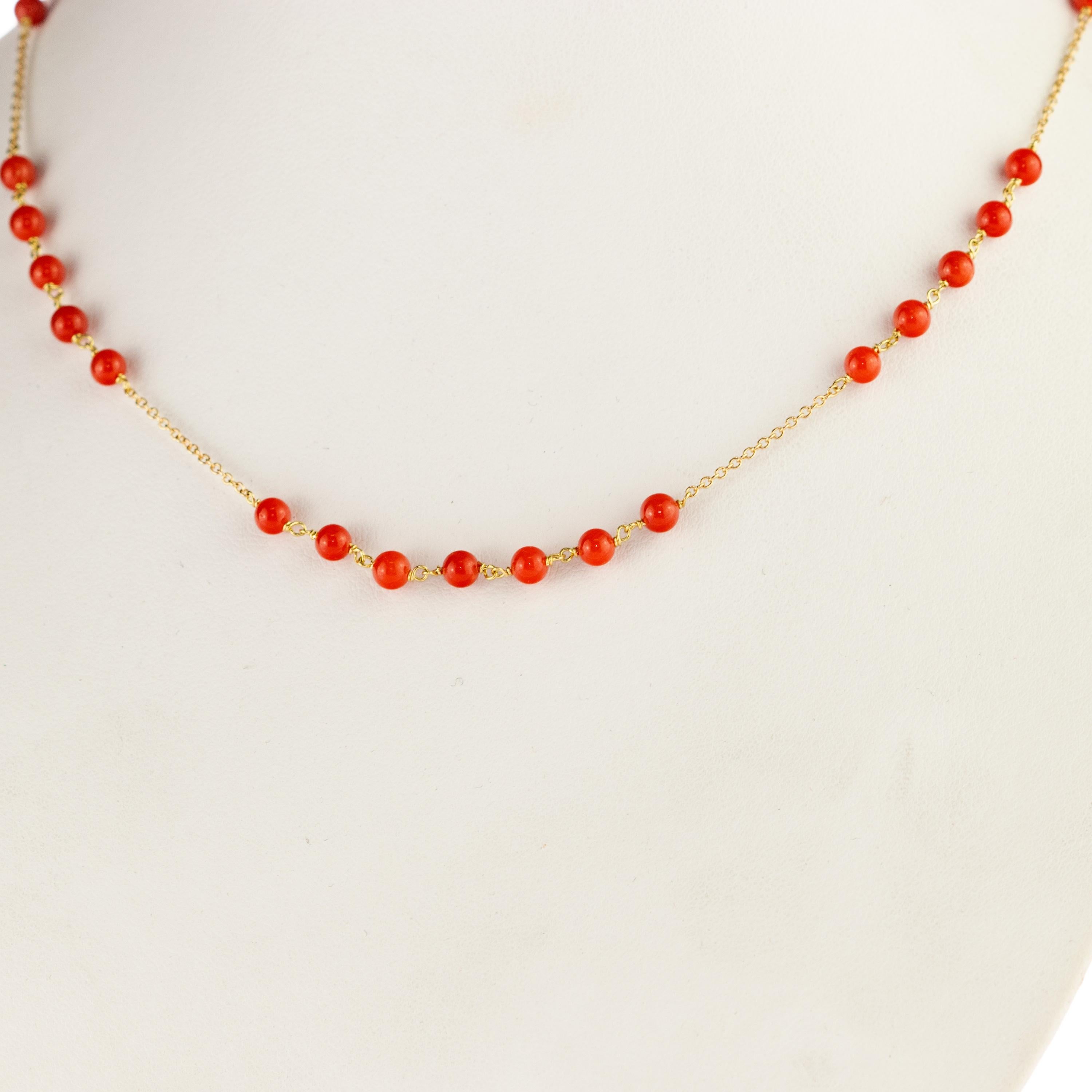Marvellous necklace starring pure red natural coral spheres, for a bright charm of uniqueness. Luminous jewel with natural precious jewellery on elegant 18 karat yellow gold setting. 
 
The origin of coral is explained in Greek mythology by the