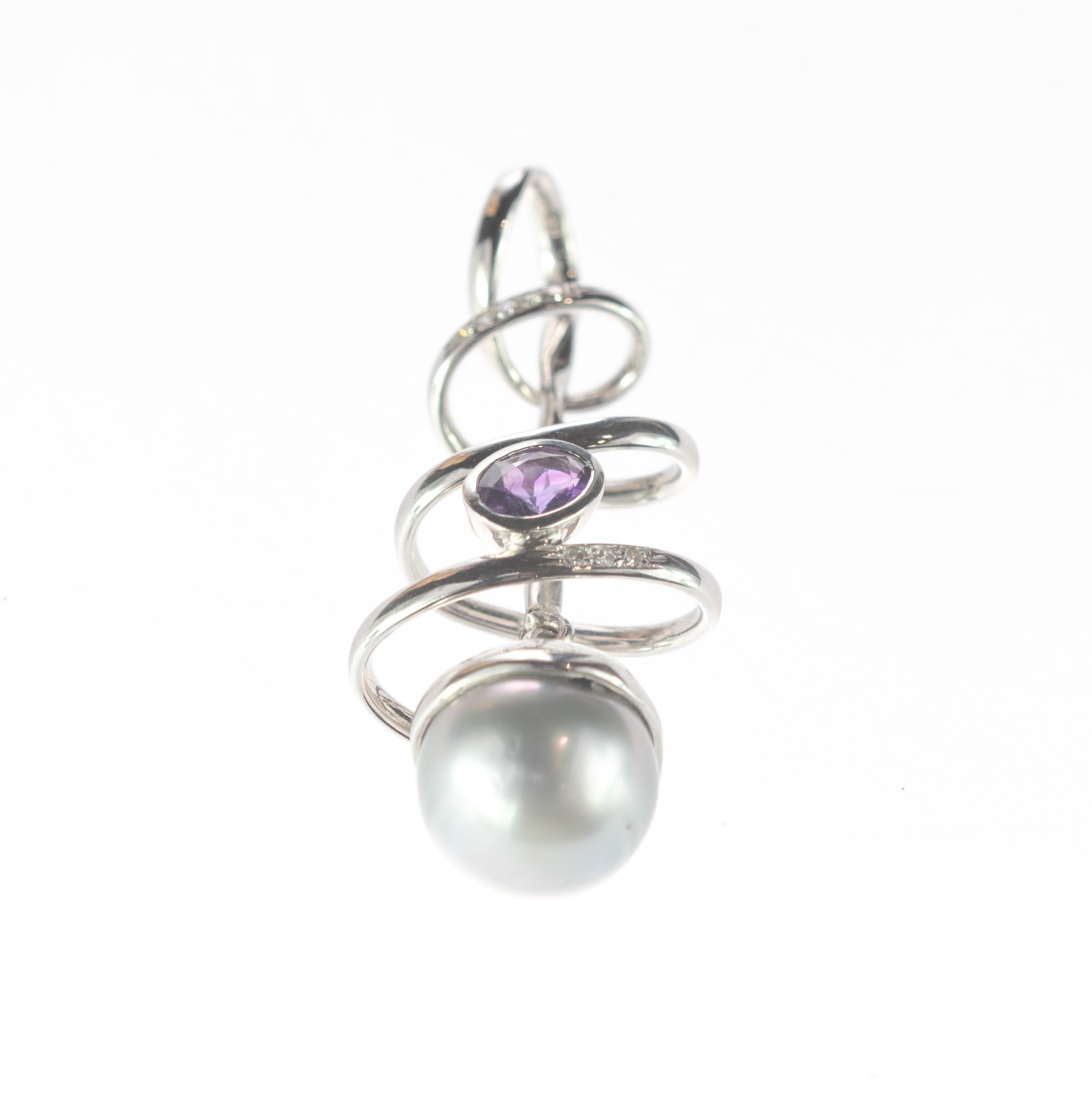 A unique and mysterious necklace pendant. Beautiful Tahitian pearl surrounded by a spiral-shaped 18 karat white gold that has an oval-shaped amethyst stone inside.  The jewel is embellished with 3 diamonds. A special design created by our italian