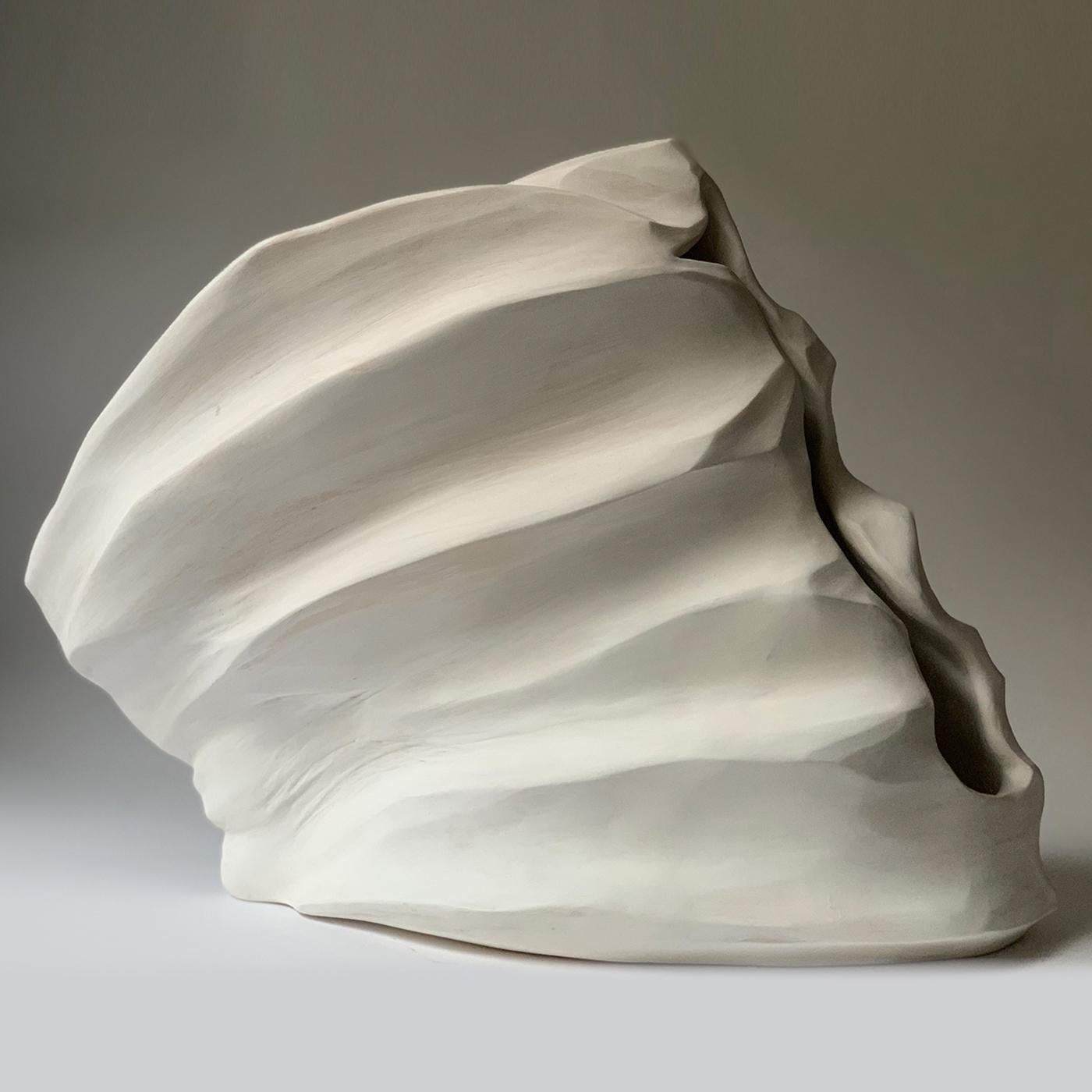 Exuding a fascinating, almost unsettling feeling in its sinuous, vertical cavity, this stupendous work of art is a ceramic sculpture that can be looked at from four different angles, every single one of them revolving around the main, intriguing