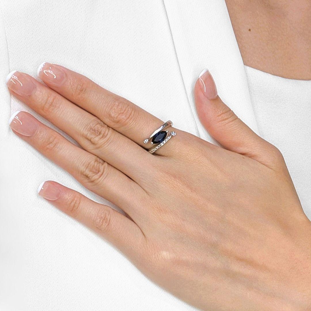 Elevate your hand with this stylish ring, meticulously crafted in luxurious Platinum 950, a true statement of refined taste. At its heart lies a captivating 1.51ct natural marquise-cut sapphire, radiating a mesmerizing dark blue hue that evokes the